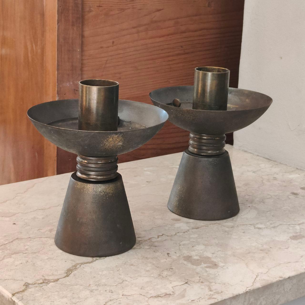 Pair of 1930s Italian Art Deco Solid Brass Candelabras with Original Patina

A striking pair of Italian Art Deco candelabras, circa 1930, crafted in massive solid brass. Each features a tapered conical base rising to a fluted stem and a broad,