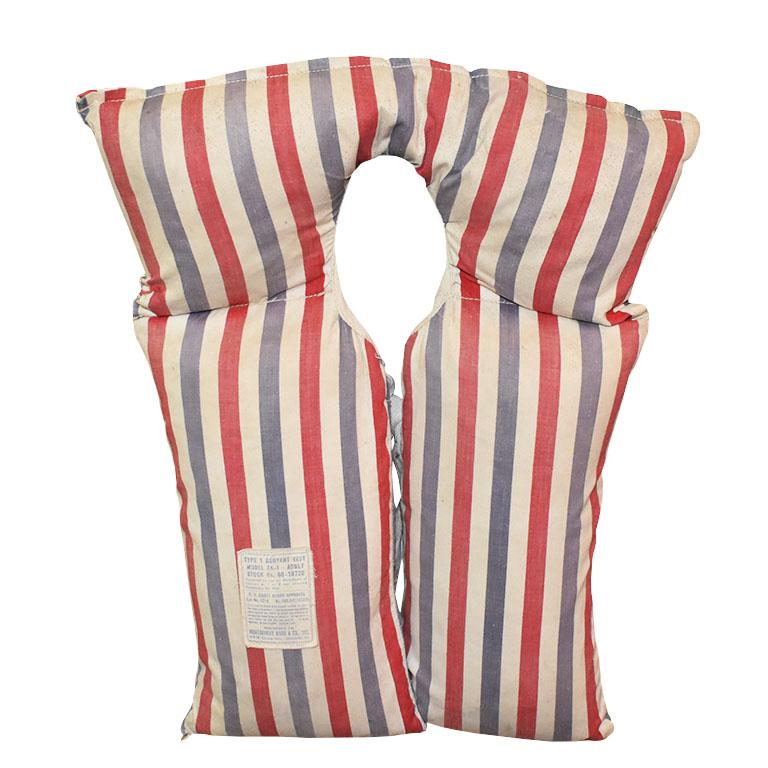A pair of vintage Montgomery Ward life jackets in red, white, and blue. This pair will be fabulous hung on a wall or even framed in a pied-à-terre or beach house. We believe this set to be from the 1930s. 

Dimensions Each:
21