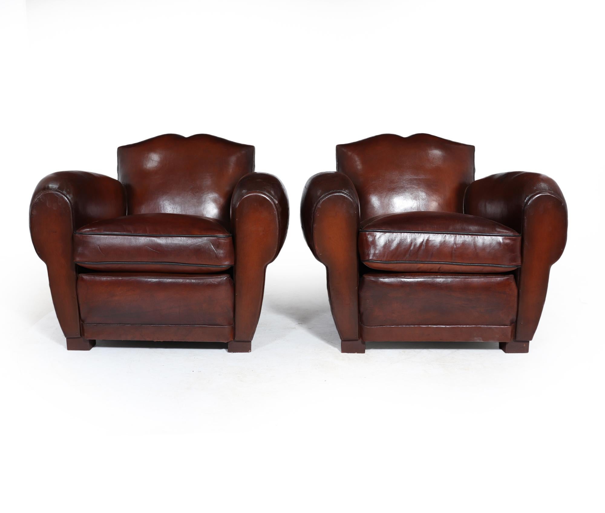 A pair of French leather moustache back club chairs are the perfect addition to any home. The chairs boast high-grade leather upholstery that has undergone treatment and sealing, ensuring durability for the years ahead. Their sturdy frames and
