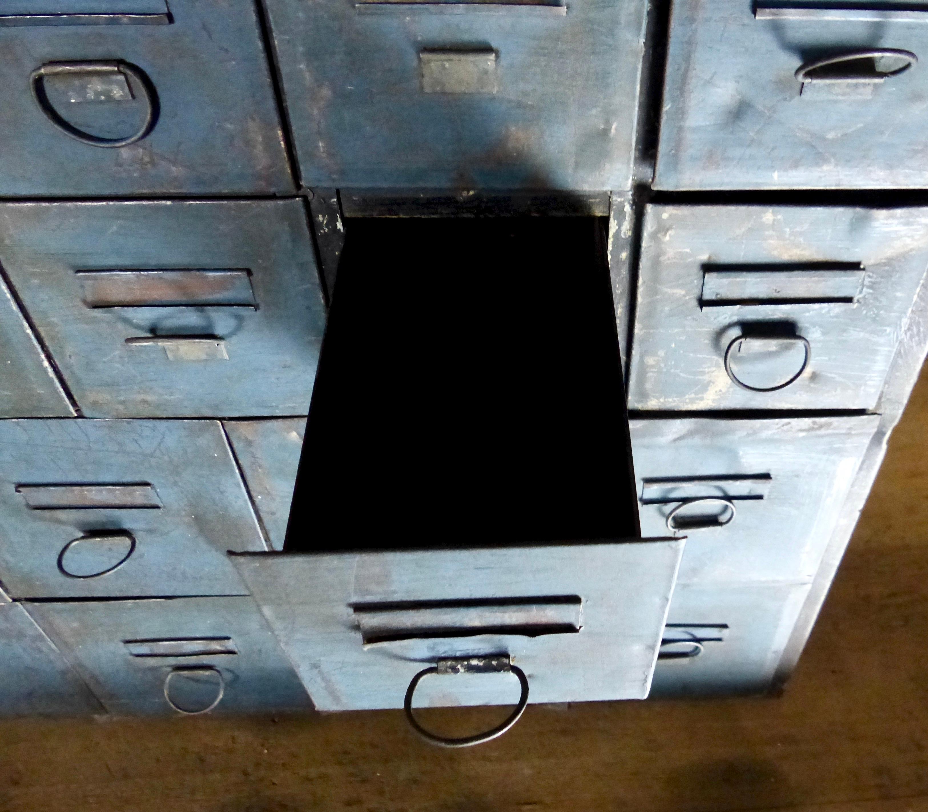 A matched pair of freestanding metal hardware/automotive cabinets, each with 28 drawers showing great blue old color. Twenty drawers are 3.5” high and eight are 5” high. Original hardware intact, handsome patina throughout.
Dimensions: 27 H” x 21.5