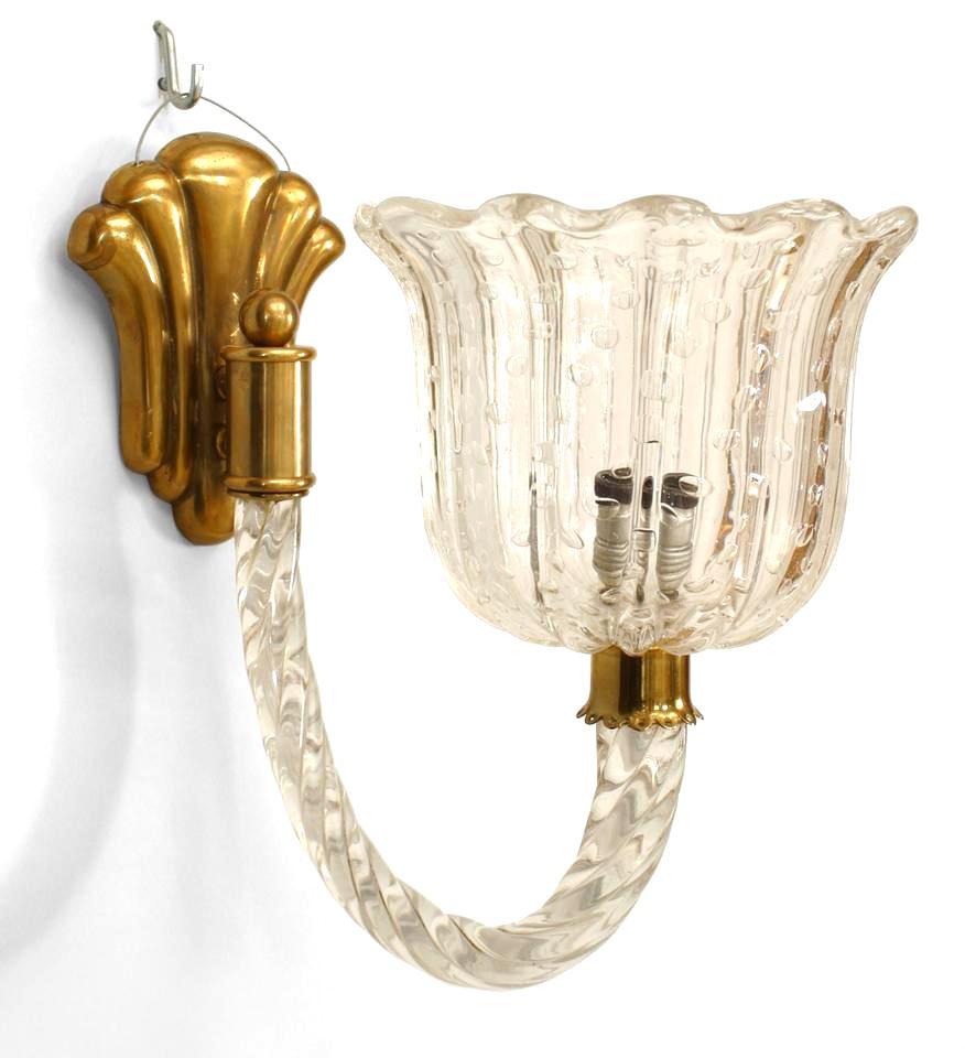 Attributed to Barovier e Toso, this pair of 1930's Venetian wall sconces is composed of clear murano glass and is distinguished by its large tulip-form shades whose swirling swivel arms emanate from fluted bronze brackets.

Barovier e Toso is a