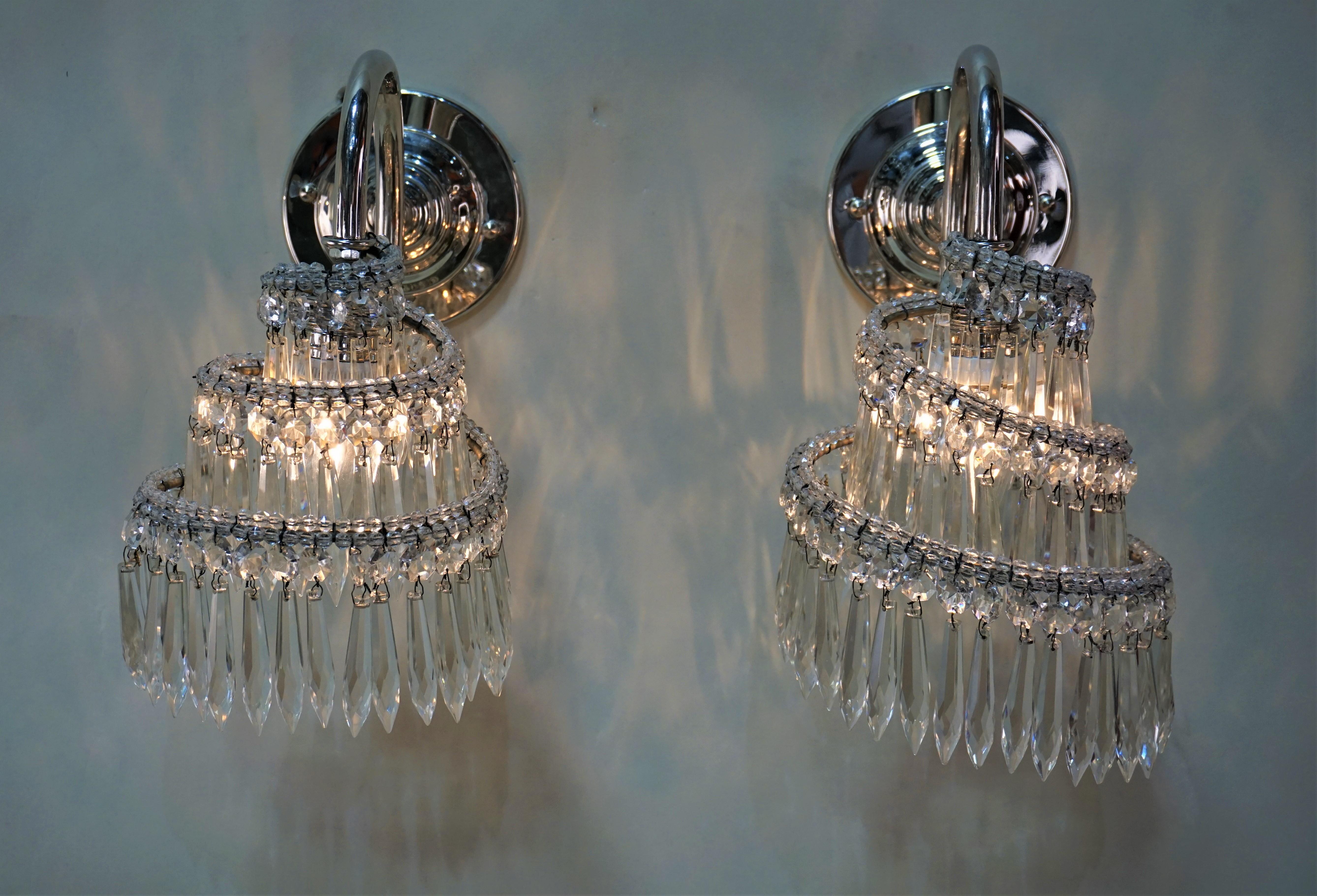 Swivel design crystal covering the light with nickel on bronze pair of wall sconces.