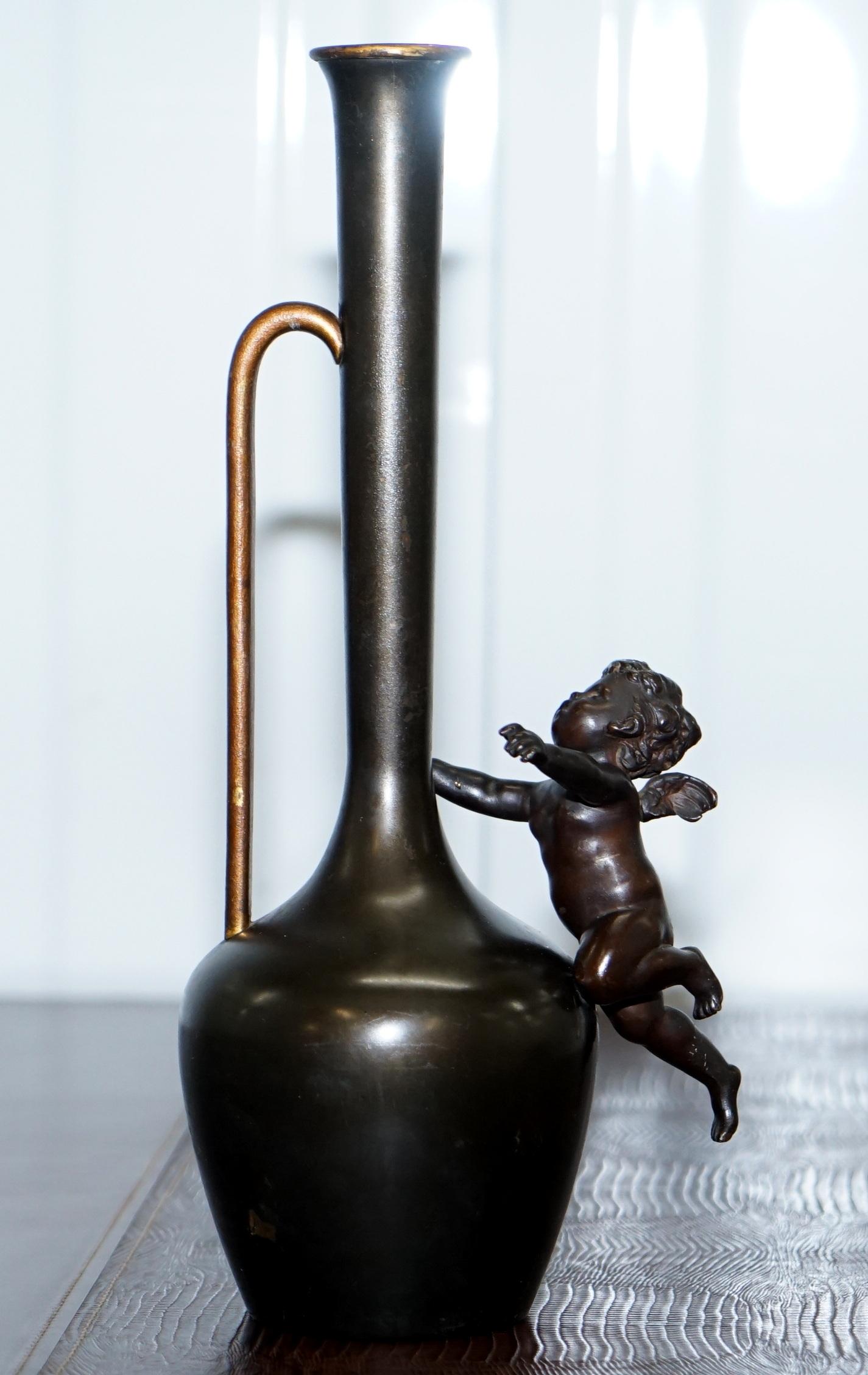 We are delighted to offer for sale this lovely original pair of 1930s bronze jug vases with cherubs

A good looking and well made pair, the Cherubs have two different positions which is much nicer than if they were holding the same pose

These