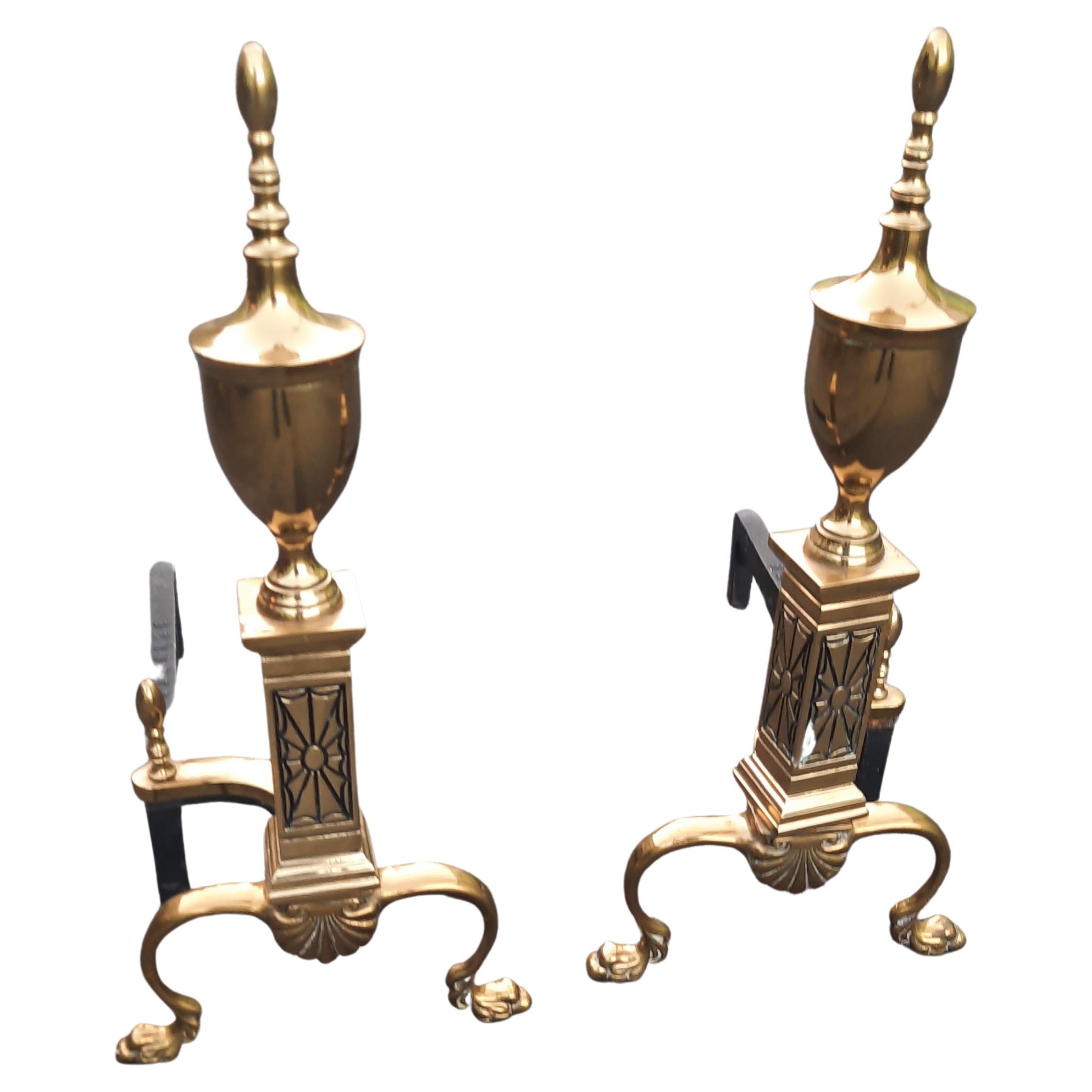 Pair of 1940s Bennett Co. chippendale style polished brass andirons with
paw feet in good condition.
Measures 9