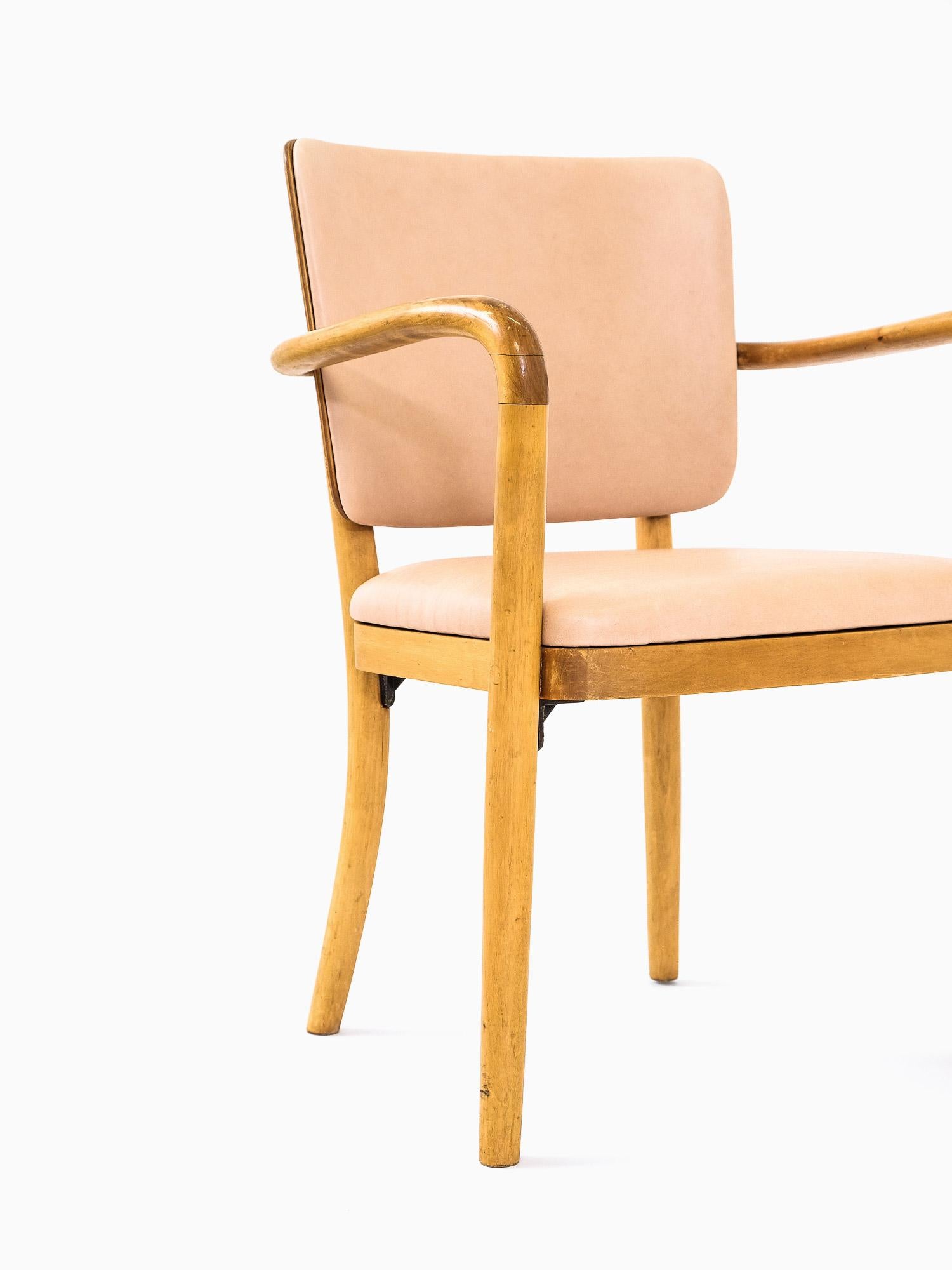 Pair of solid birch and birch veneer armchairs designed in 1940s Finland by Werner West. Manufactured by Wilhelm Schaumann Oy.

Professionally reupholstered with premium aniline leather from Sorensen Leather. Also seat and back padding is new.