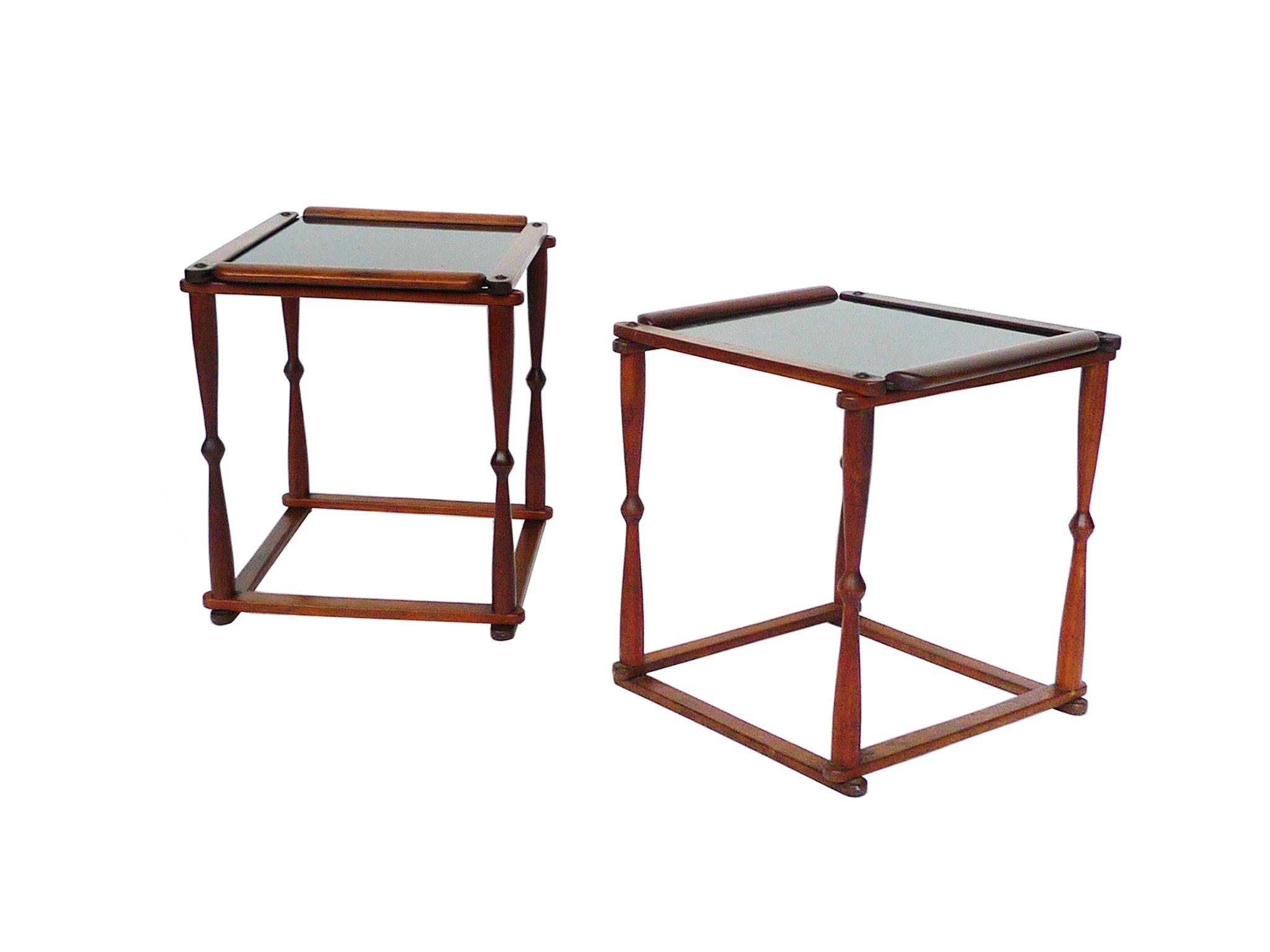 A charming pair of 1940s Campaign-style end-tables. They are comprised of collapsible walnut frame and removable hardboard tray inserts. The trays are coated with a black lacquer finish, giving the surface a chic gloss. The legs are a slender