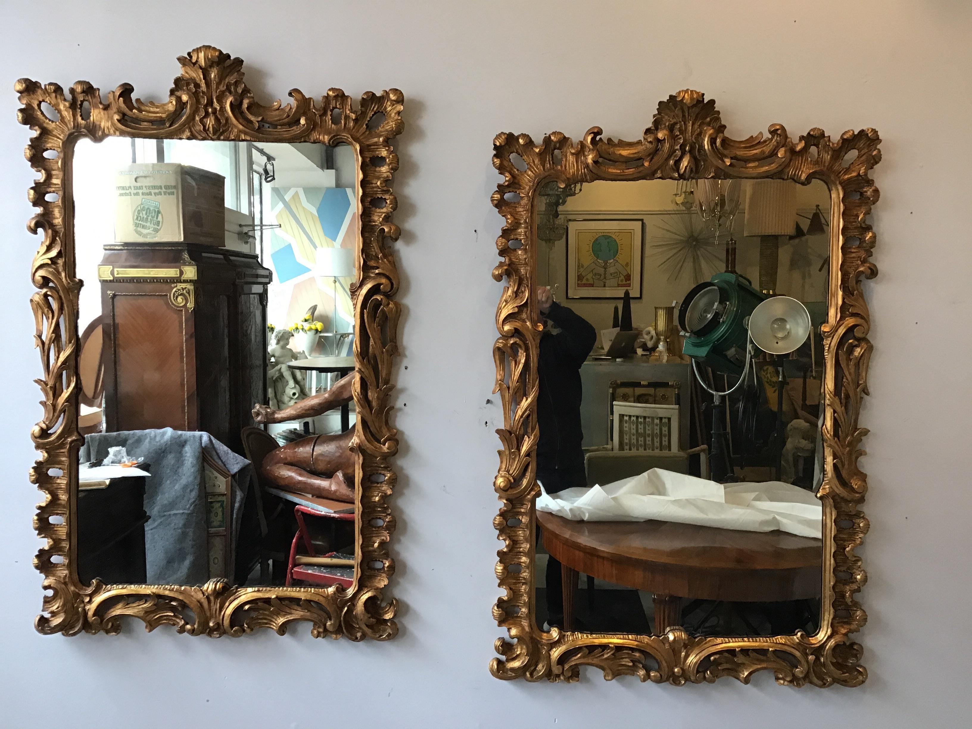 Pair of 1940s carved wood gilt mirrors from Harris Interiors Arts, New York City.