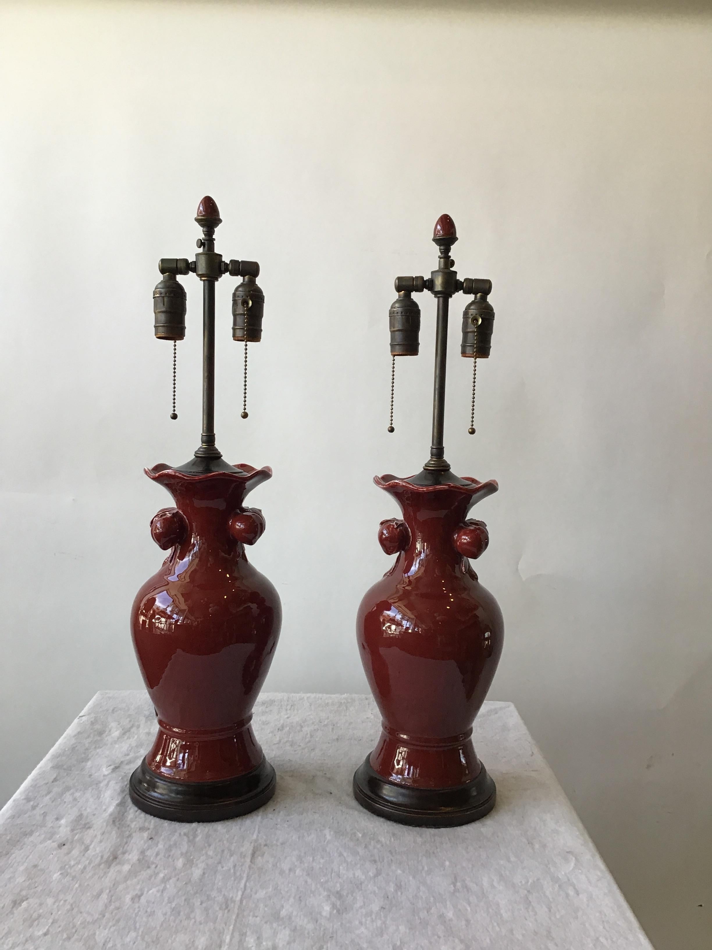 Pair of 1940s ceramic oxblood lamps
On wood base
With ceramic finial.