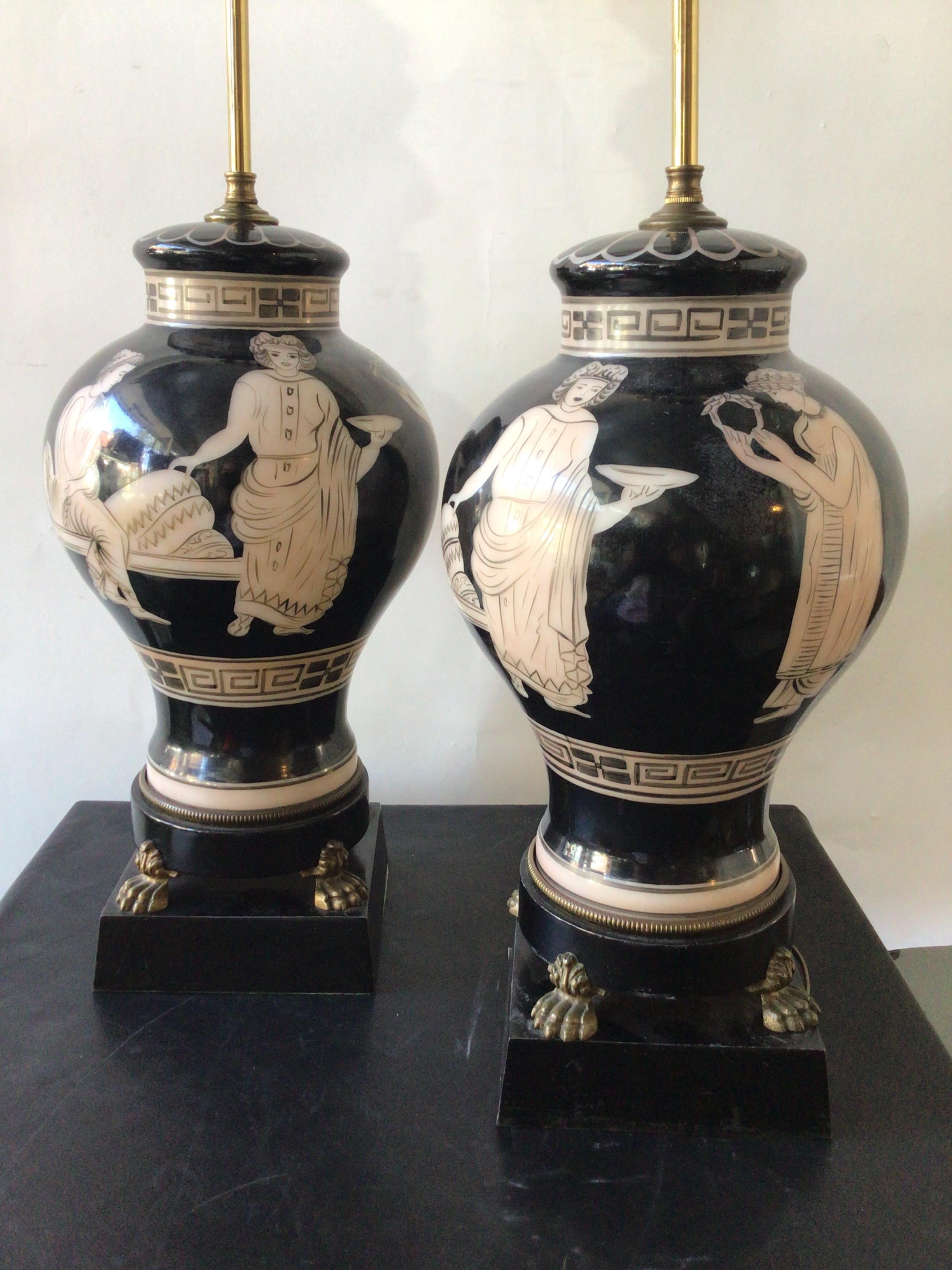 Pair of 1940s hand painted ceramic classical lamps on metal bases with brass feet.