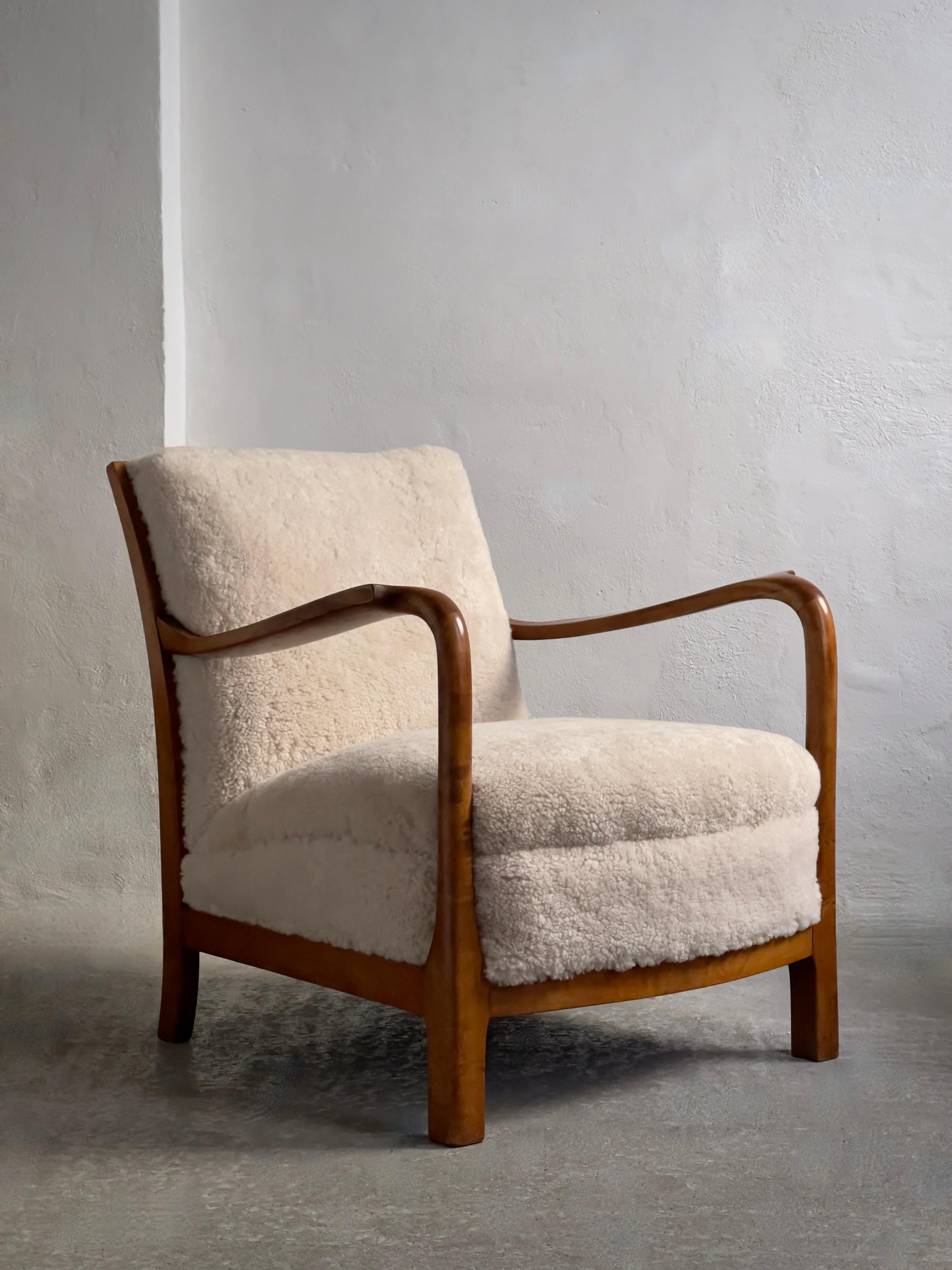 1940s pair of danish lounge chairs in solid flamed birch and premium sheepskin. 6