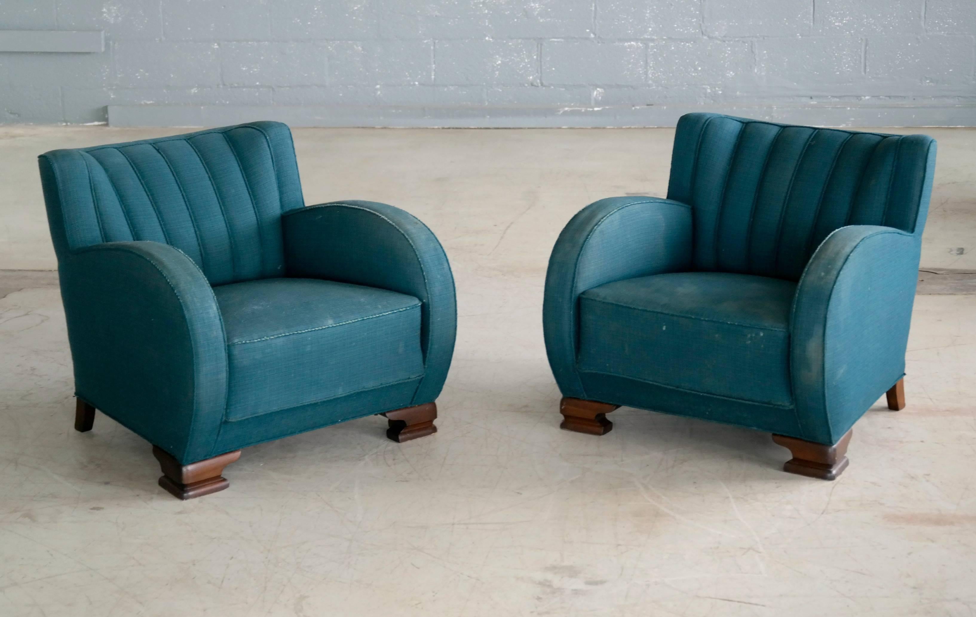 Exuberant, curvy and very eye-catching pair of Danish lounge chairs from the 1940s.
Set on block feet typical of the period and with a channeled back reminiscent of sports car seats of the era. Sturdy and sound construction but with significant
