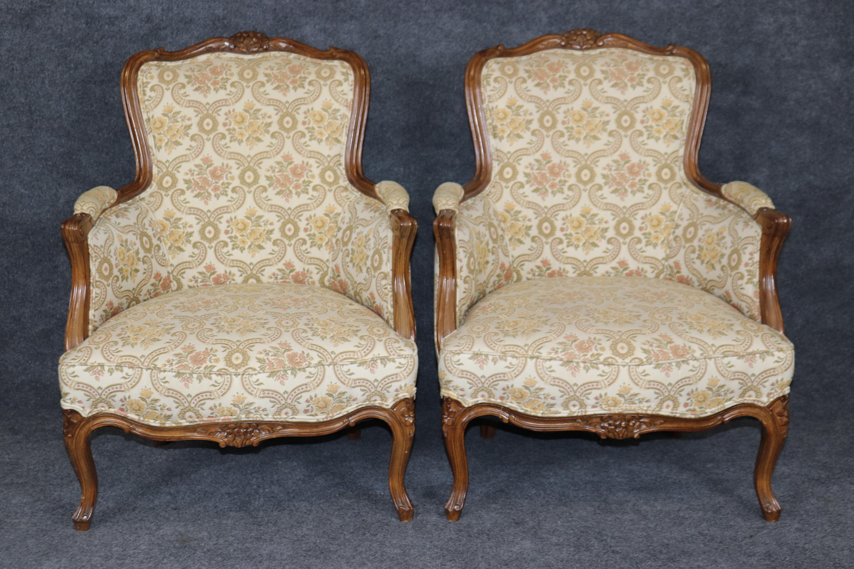 This is a gorgeous pair of 1940s era bergère chairs from France. The chairs have nice frames and design elements. The upholstery is original and may show signs of age and the frames may show old repairs and touch ups to the finish on the backs. The