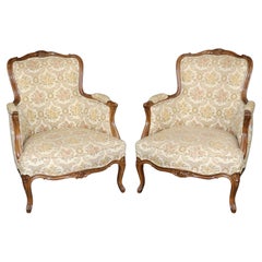 Pair of 1940s era French Walnut Carved Louis XV Style Bergere Lounge Chairs