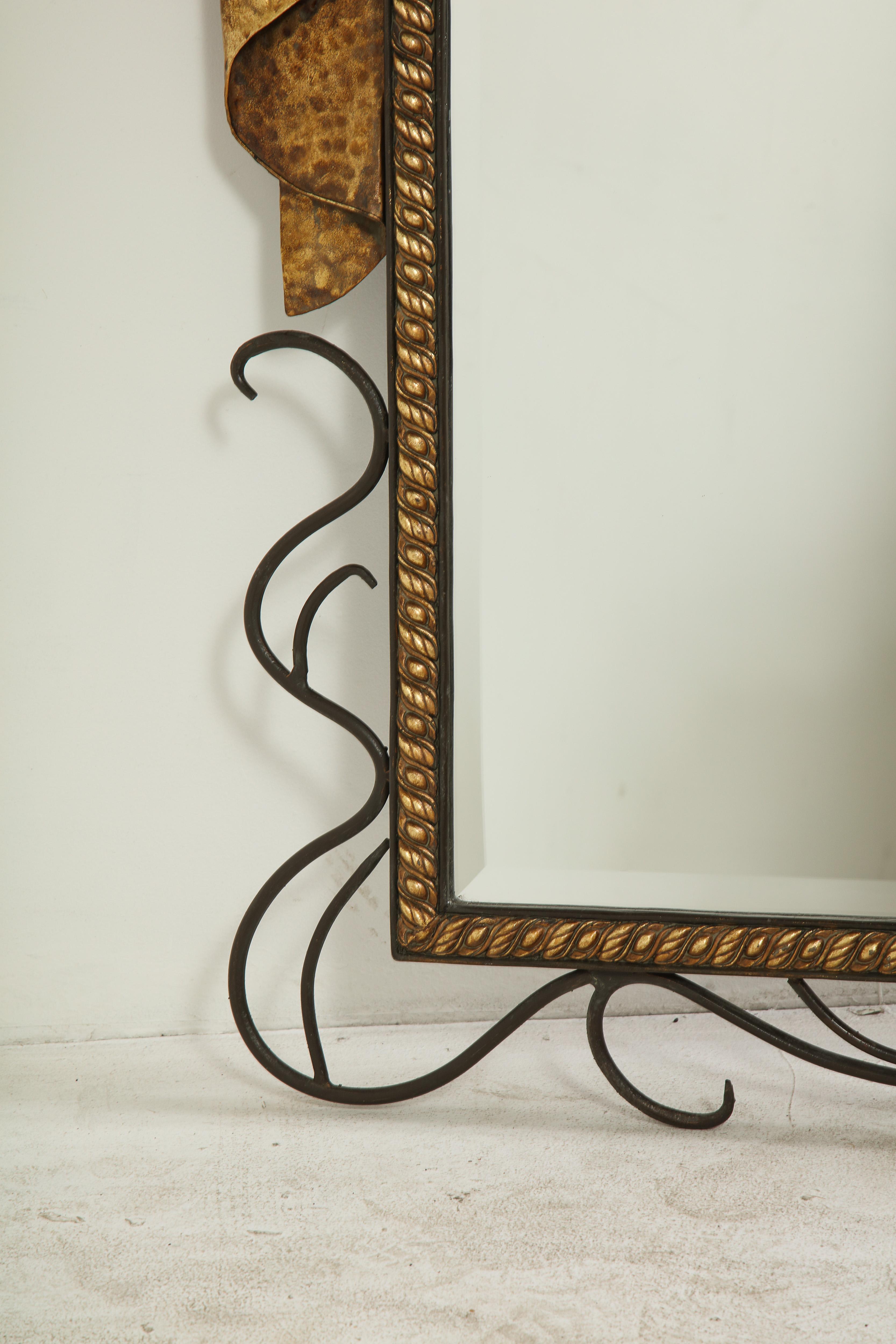 Mid-20th Century Pair of Gilbert Poillerat Style Parcel-Gilt and Black Iron Wall Mirrors