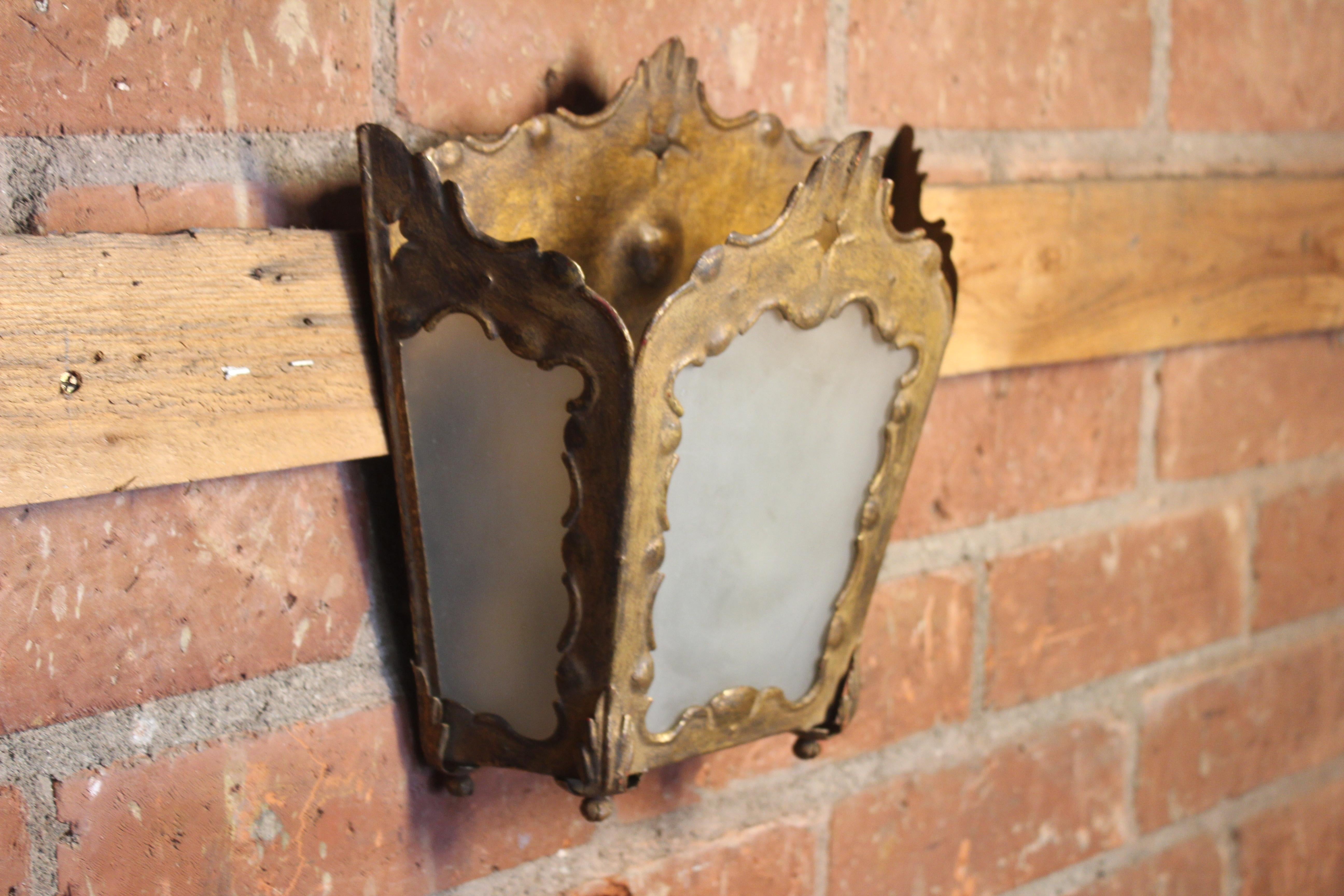 A pair of vintage 1940s French guilt metal sconces with frosted glass panels. Sold as a pair. They are both in good original condition.