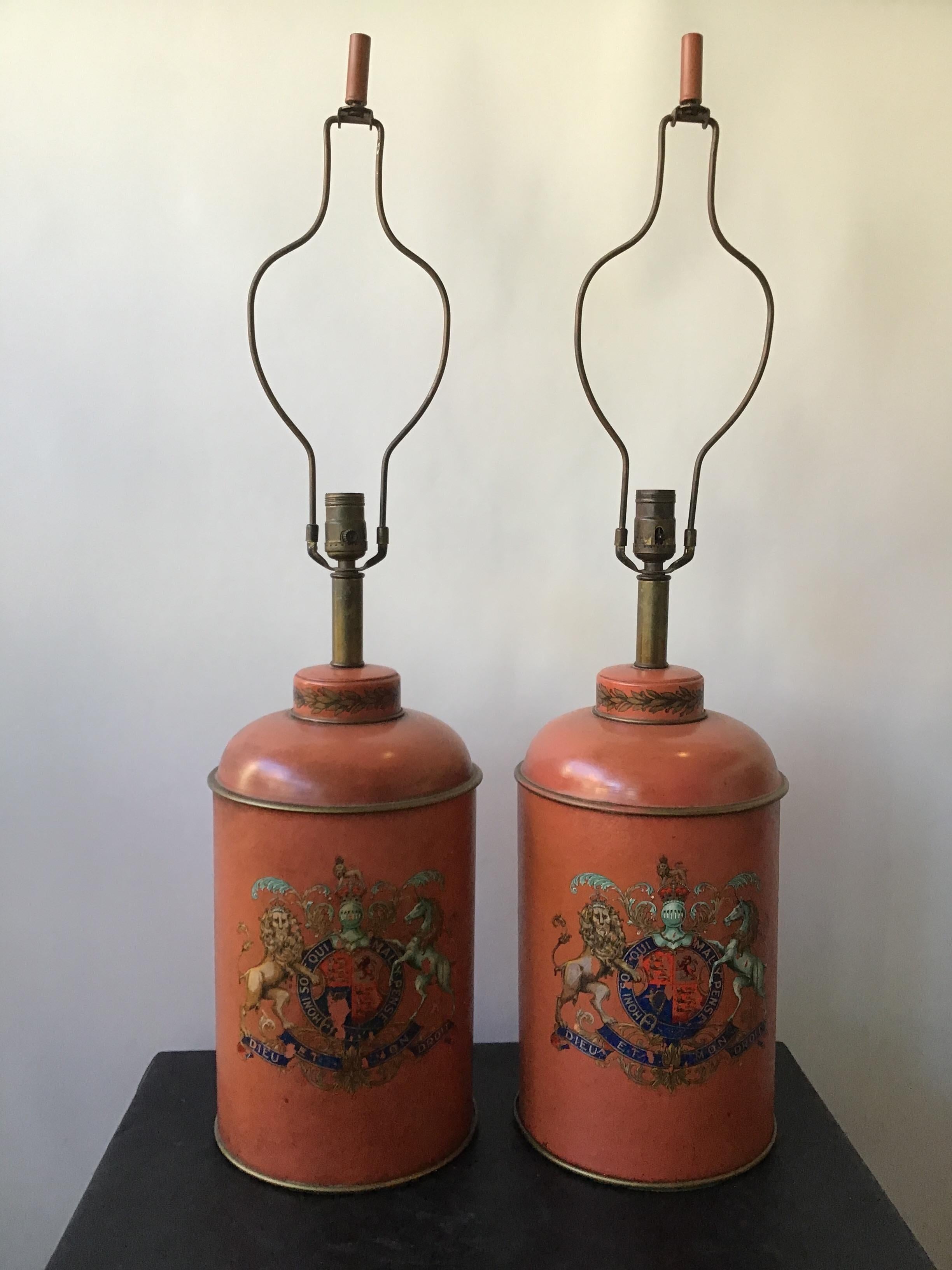 Pair of 1940s French Leather lamps with a crest that reads, Honi so it qui mal y Penske. This translates to, shame on anyone who thinks evil of it. Used as the motto of the British chivalric Order of the Garter.