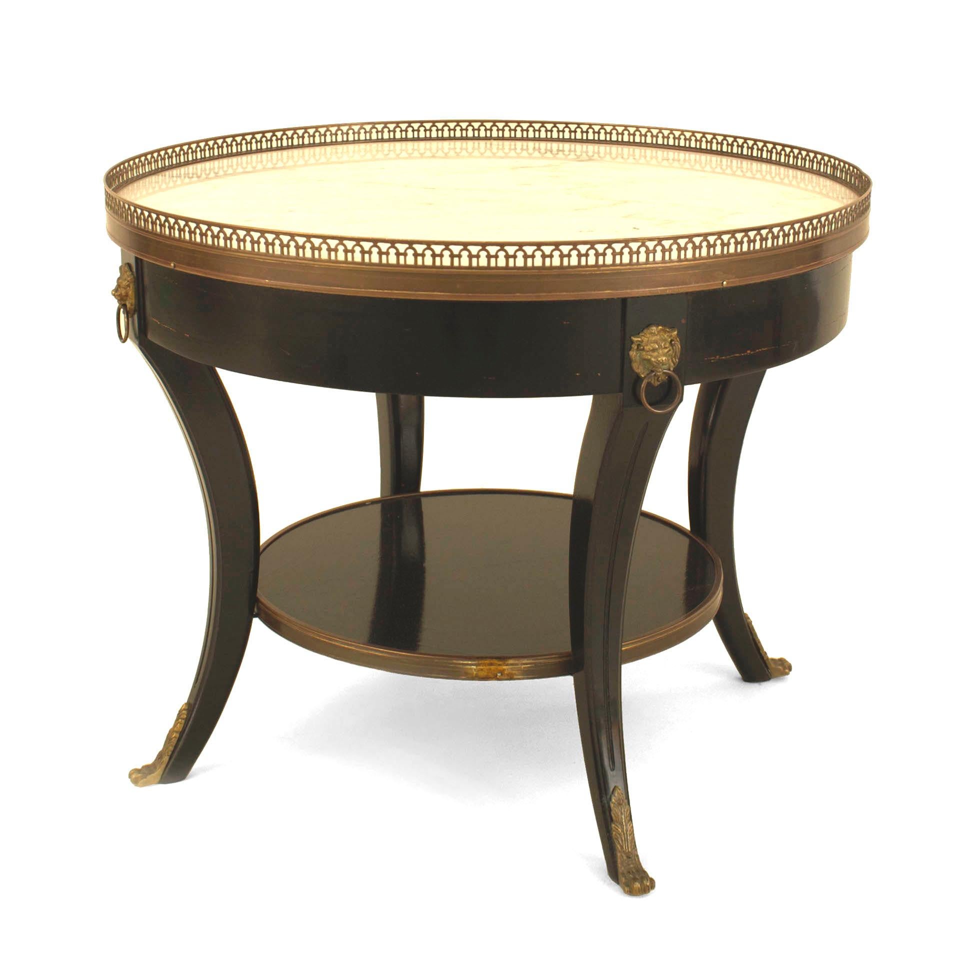 Pair of French Louis XVI-style (1940s) ebonized and bronze trimmed low round end tables with white marble tops having a filigree bronze gallery with a shelf stretcher. (Attributed to MAISON JANSEN) (PRICED AS Pair)
