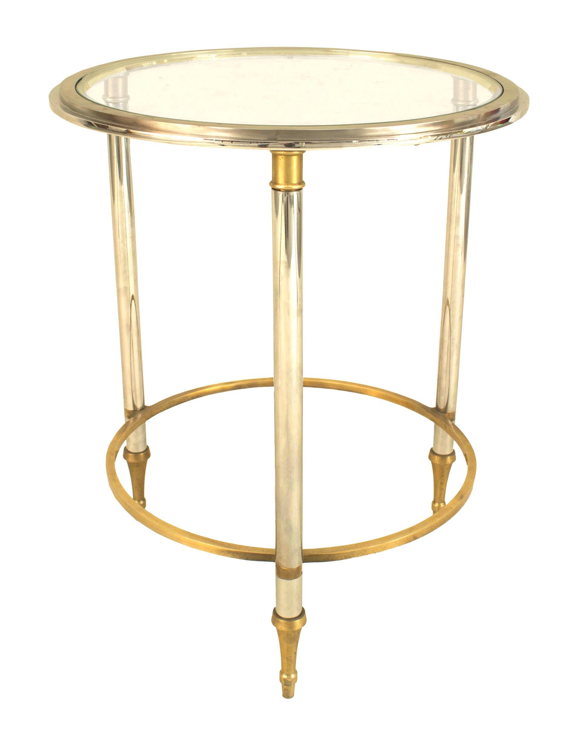 Pair of French 1940s gilt bronze trim end tables with 3 tubular glass legs connected with a ring stretcher supporting a round inset glass top (att: JANSEN).

Maison Jansen was a Paris-based interior decoration office founded in 1880 by Dutch-born