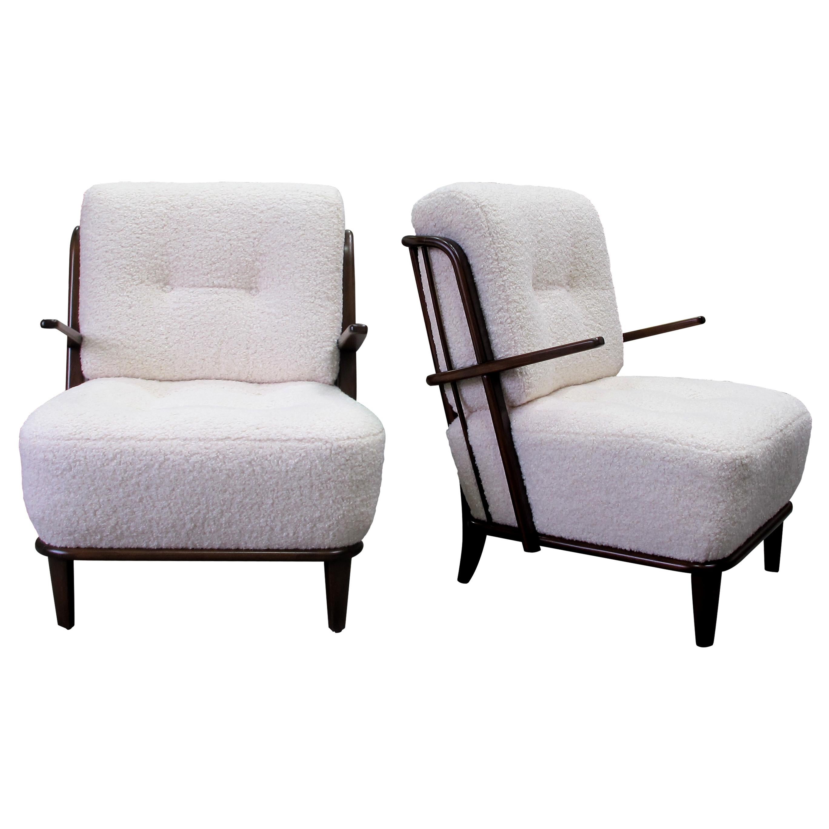 This is a very elegant pair of oak frame armchairs, made in Germany in the 1940s, newly upholstered in a soft boucle fabric.  The defining feature of these armchairs is the meticulously designed backrest with round bars that add a touch of