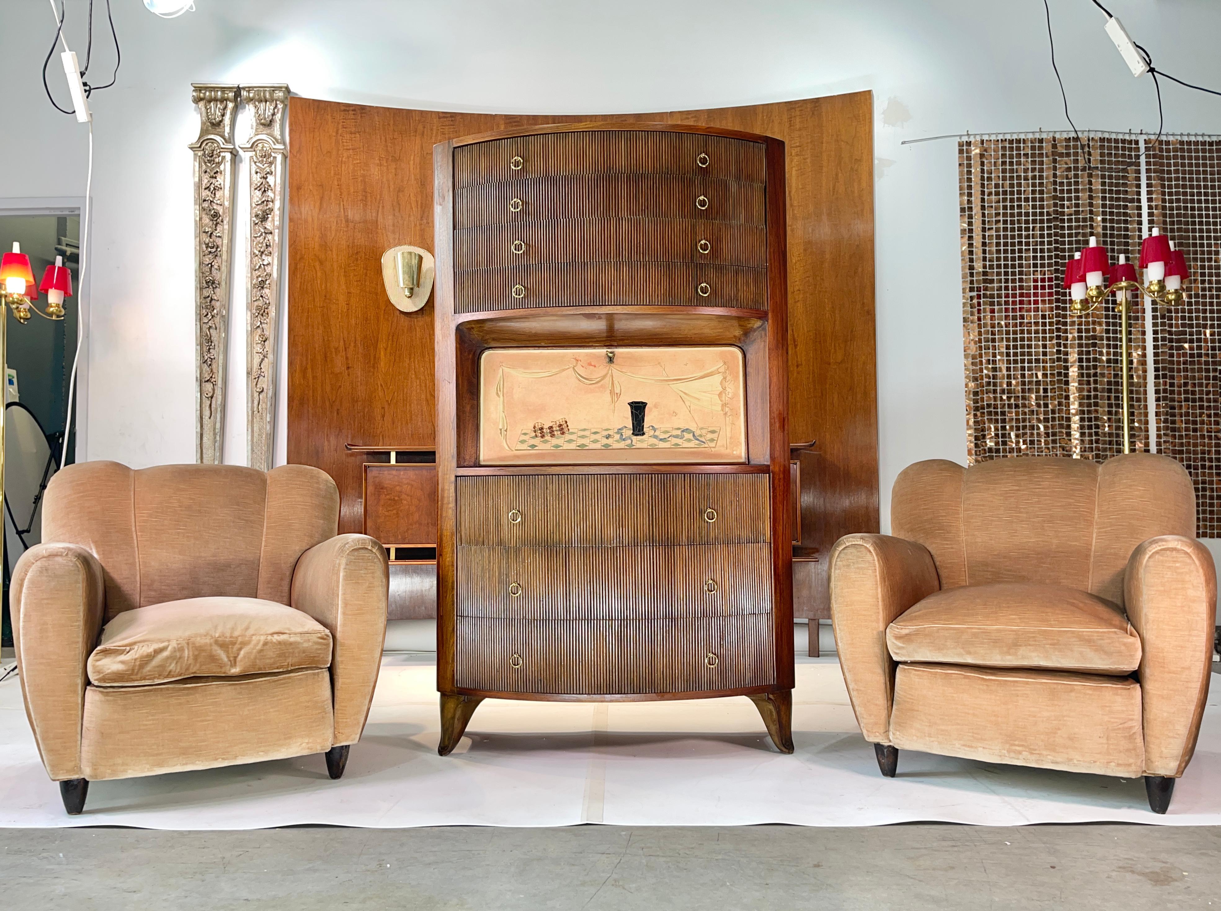 Supremely stylish 1940's Italian arm or club chairs attributed to Guglielmo Ulrich in their original silk velvet, goose down cushions and wooden cone feet.
The silk component in the velvet makes these chairs appear to change color.  They are