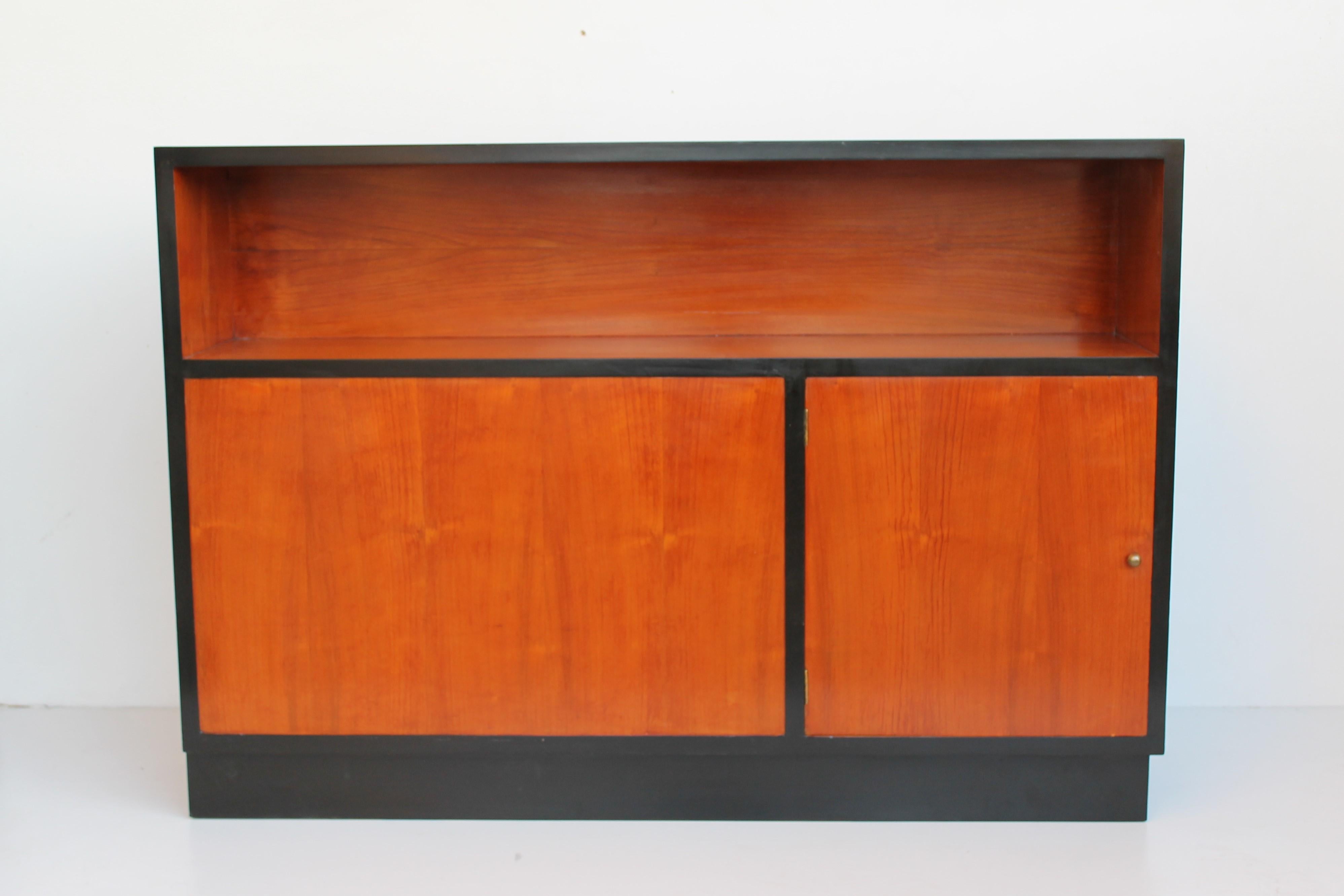 Pair of Italian cabinets or bookcase, natural cherrywood with black details. These pieces can be put in the center of a room as they are both double sides.

One is completely restored, the second will be restored without additional cost.