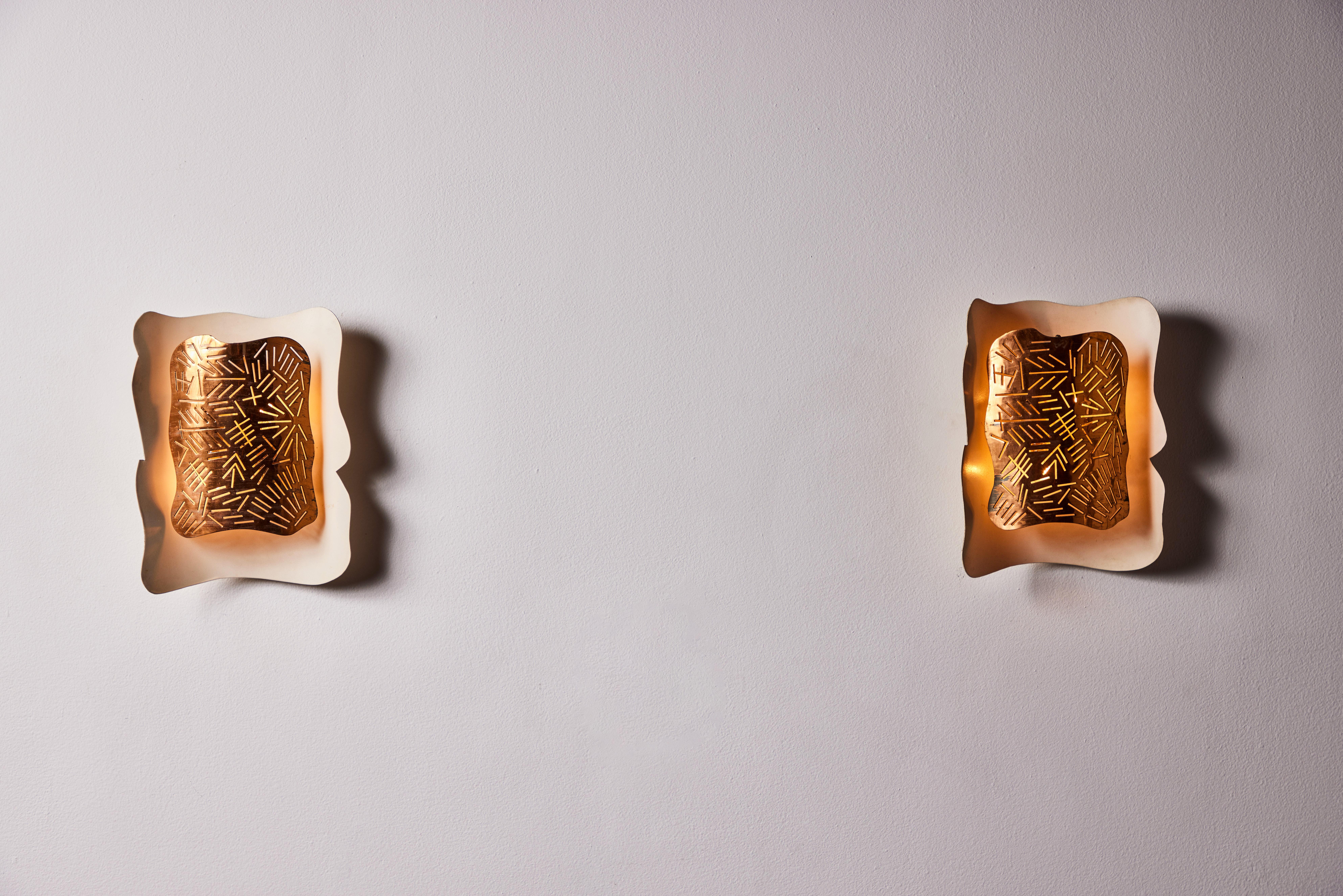 Pair of futurist sconces. Designed and manufactured in Italy, circa 1940s. Copper, enameled aluminum. Rewired for U.S. standards, no US backplate.  We recommend 2 E12 25w maximum bulbs per fixture. Bulbs provided as a onetime courtesy.