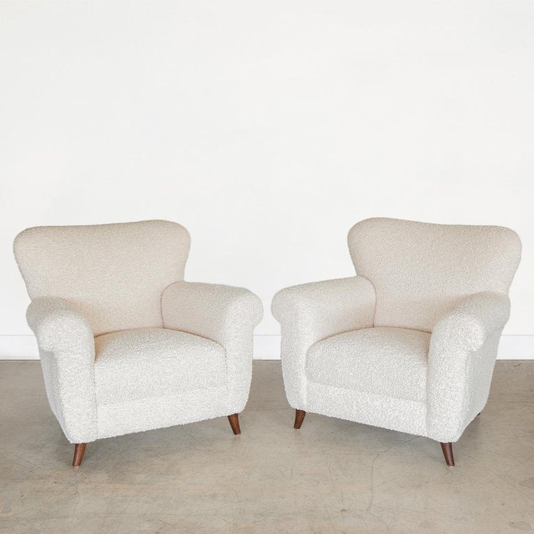 Incredible pair of vintage Italian armchairs from the 1940's. Large and curvy seats newly upholstered in a soft poodle material. Original wood tapered feet with dark stain. Beautiful from all angles and extremally comfortable. Sold as a pair.