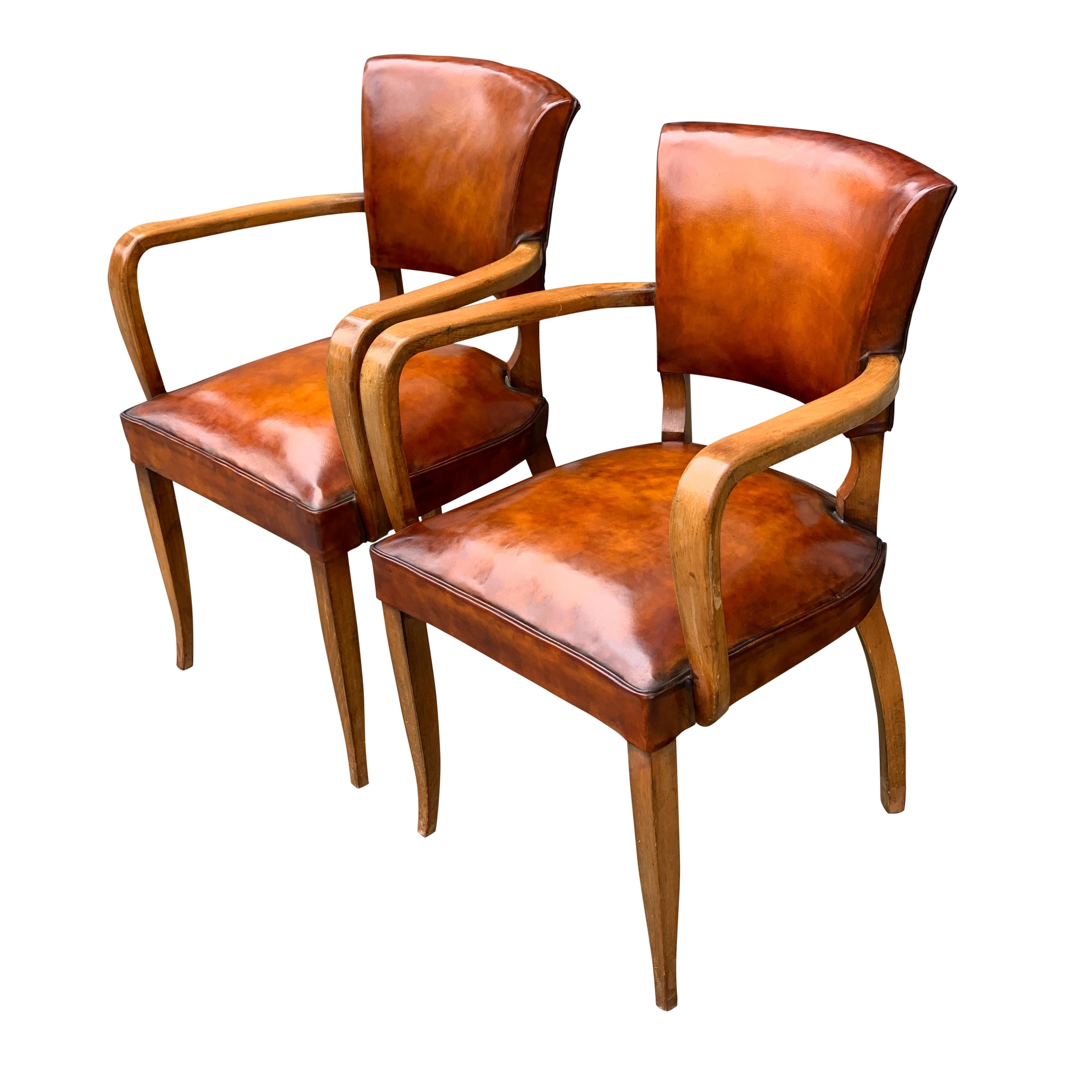 A stunning pair of 1940s bridge chairs, the chairs has been reupholstered with new conker brown leather to try and emulate as close as possible the original material, but leaving a crisp and fresh looking pair of chairs.