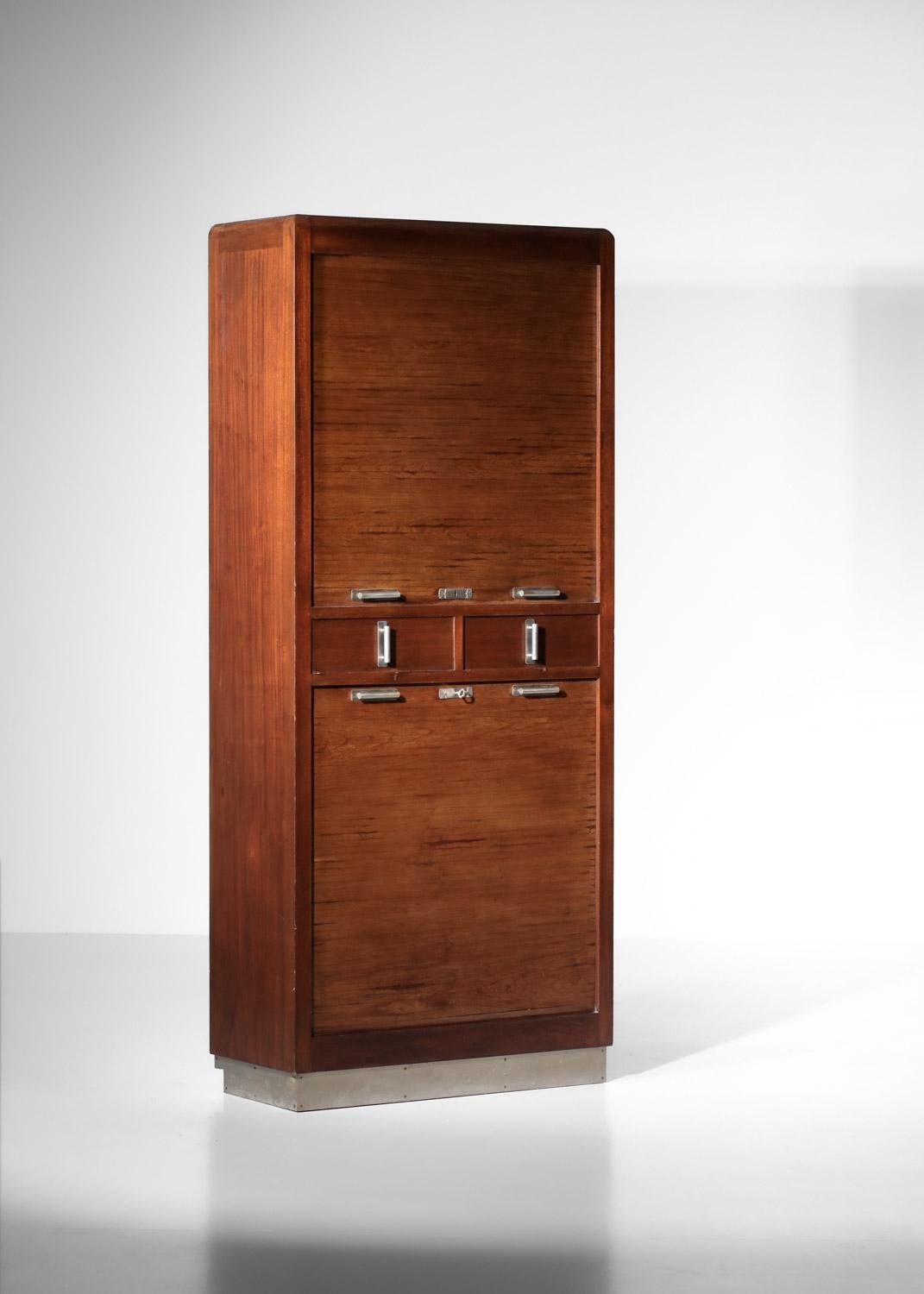 Pair of modernist French cabinets from the '40s. Structure in solid and veneered mahogany, handles and lock in nickel-plated brass. The cabinets feature two sliding curtains opening onto a series of shelves and two central drawers. Sober, elegant