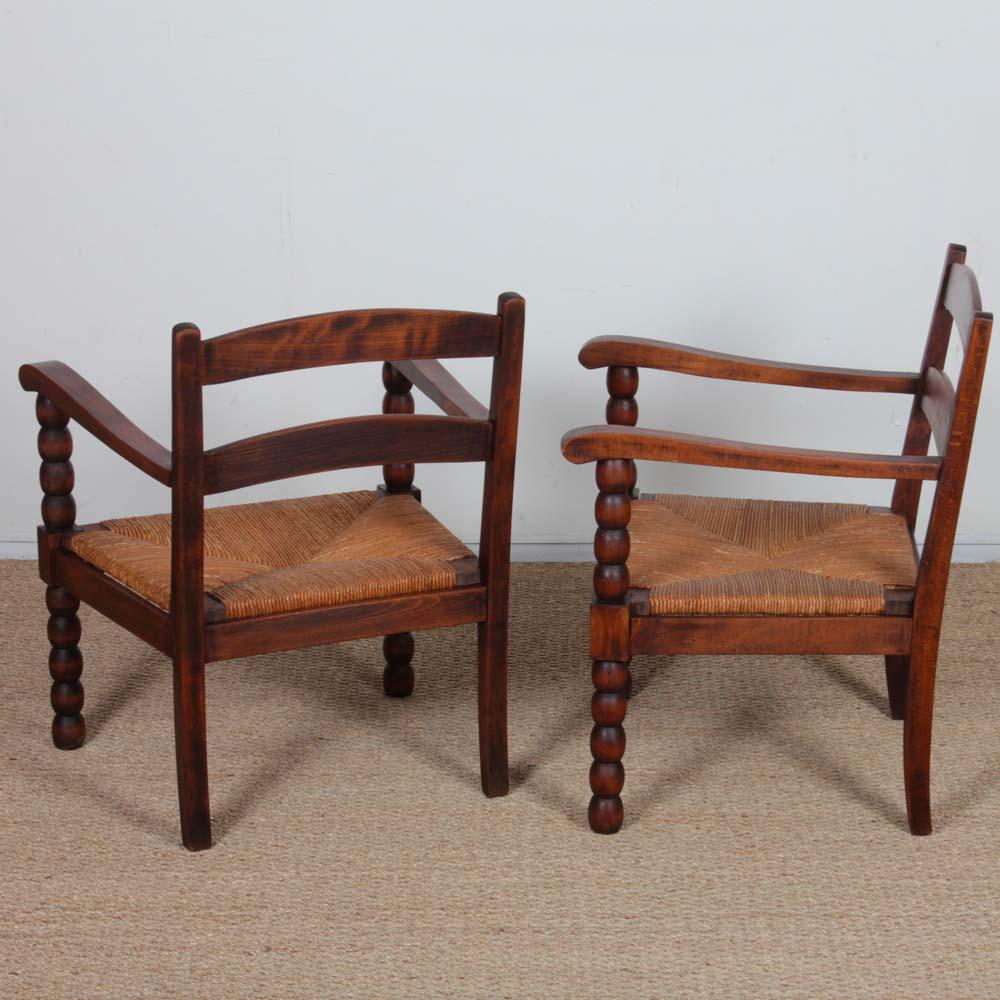 Paille Pair of 1940s oak and straw armchairs en vente