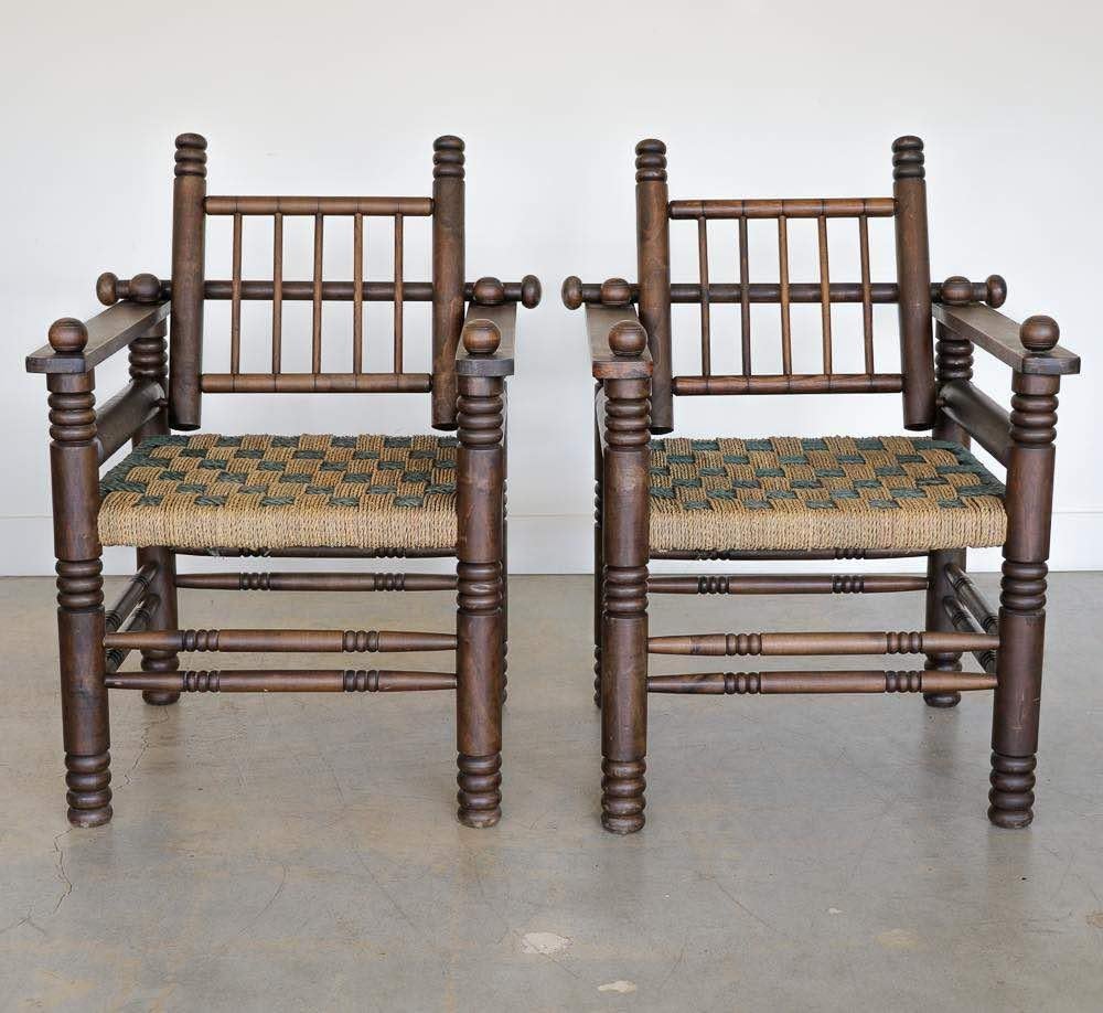 Stunning pair of 1940's French oak and woven armchairs by Charles Dudouyt. Beautiful carved wood detail throughout with intricately woven tan and green papercord seat. Adjustable slat back folds forward onto seat. Original finish and papercord show