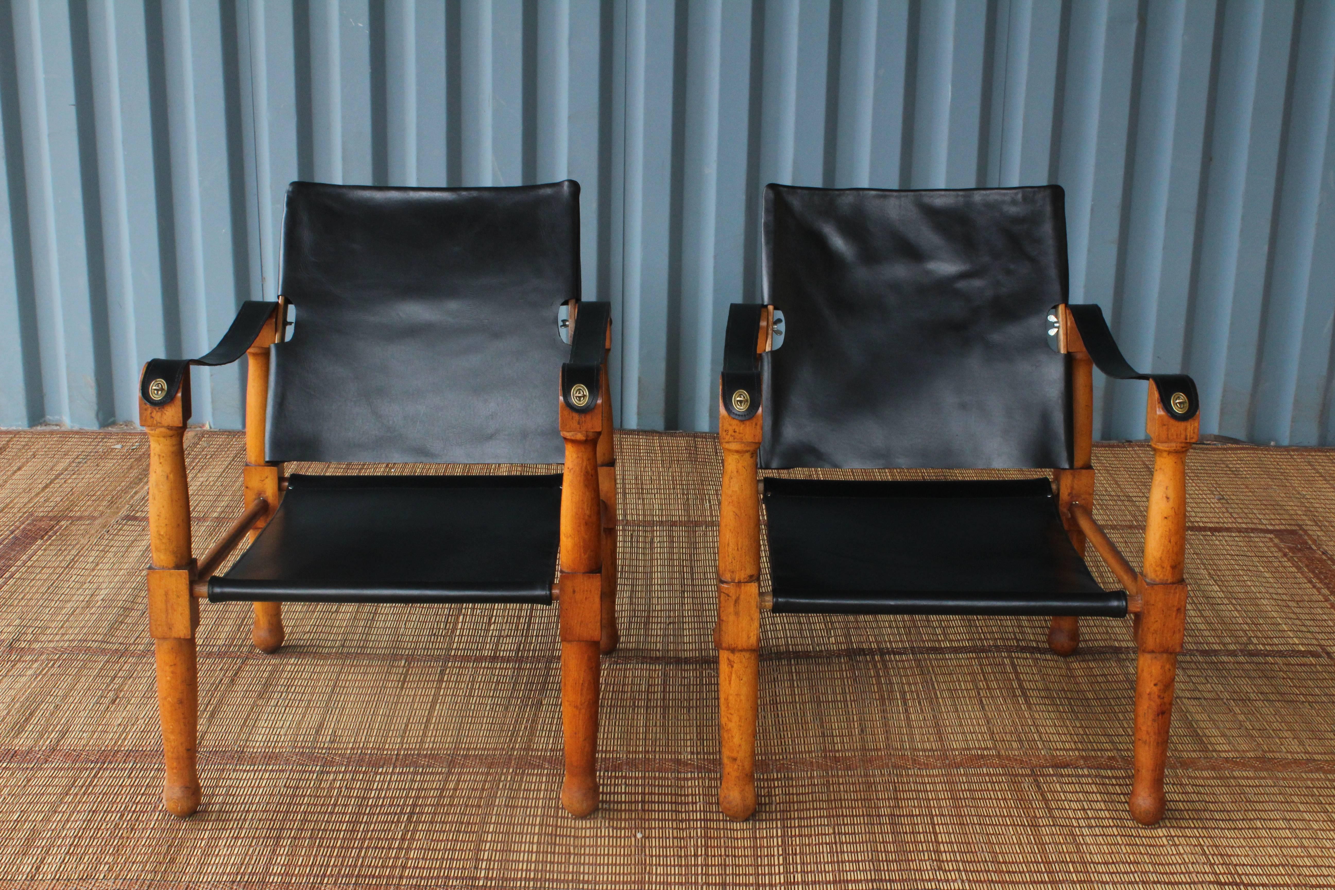 Pair of 1940s Scandinavian safari chairs with beech frames and leather slings. Frames retain their original patina and feature all new leather slings.