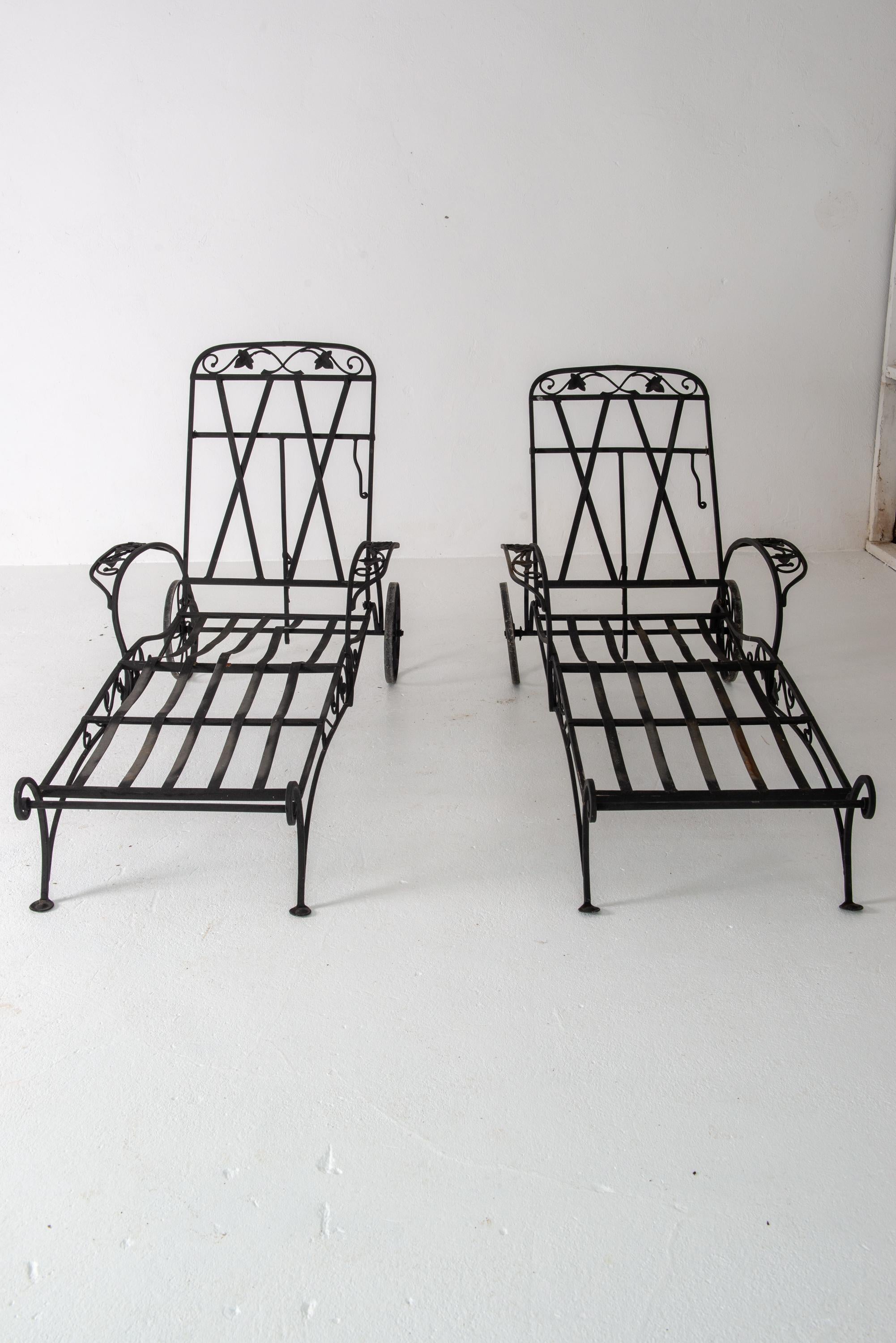 This is a pair of Hollywood Regency mid 20th century wrought iron chaise lounges designed and manufactured in the USA by the legendary John Salterini.  John B. Salterini Company wrought iron furniture was and still is the pinnacle of high quality