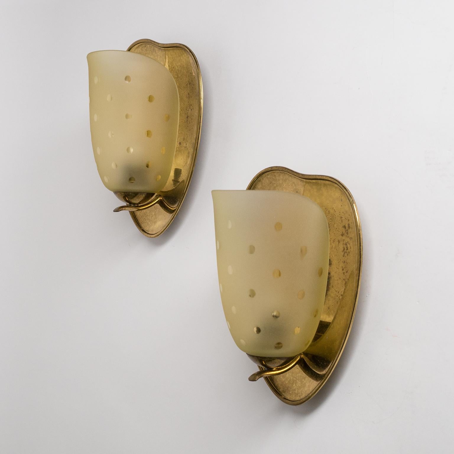 Fine pair of 1940s Art Deco sconces in brass and amber tinted glass. The blown glass tulips are frosted with clear dots. Nice original condition with a rich patina on the brass and one original brass and ceramic E27 socket per light.