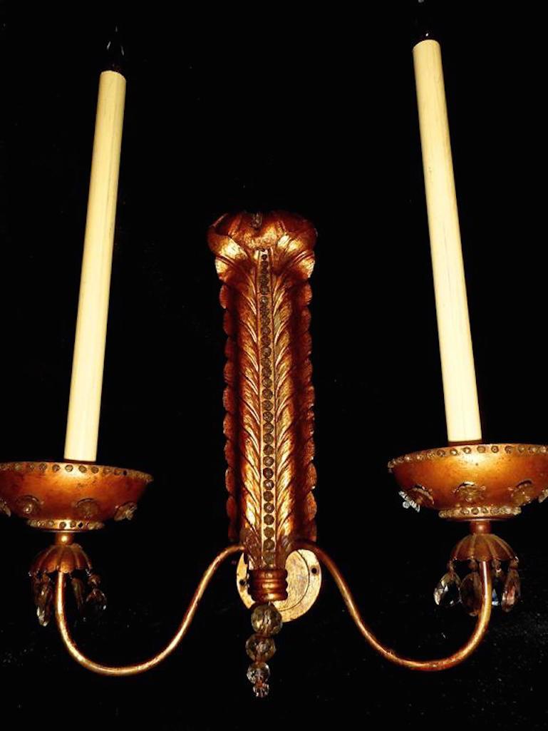 Spectacular, end of the 1940s by Baguès. Gilt metal and crystals. Three lights each sconce (one at back of the plume).
 