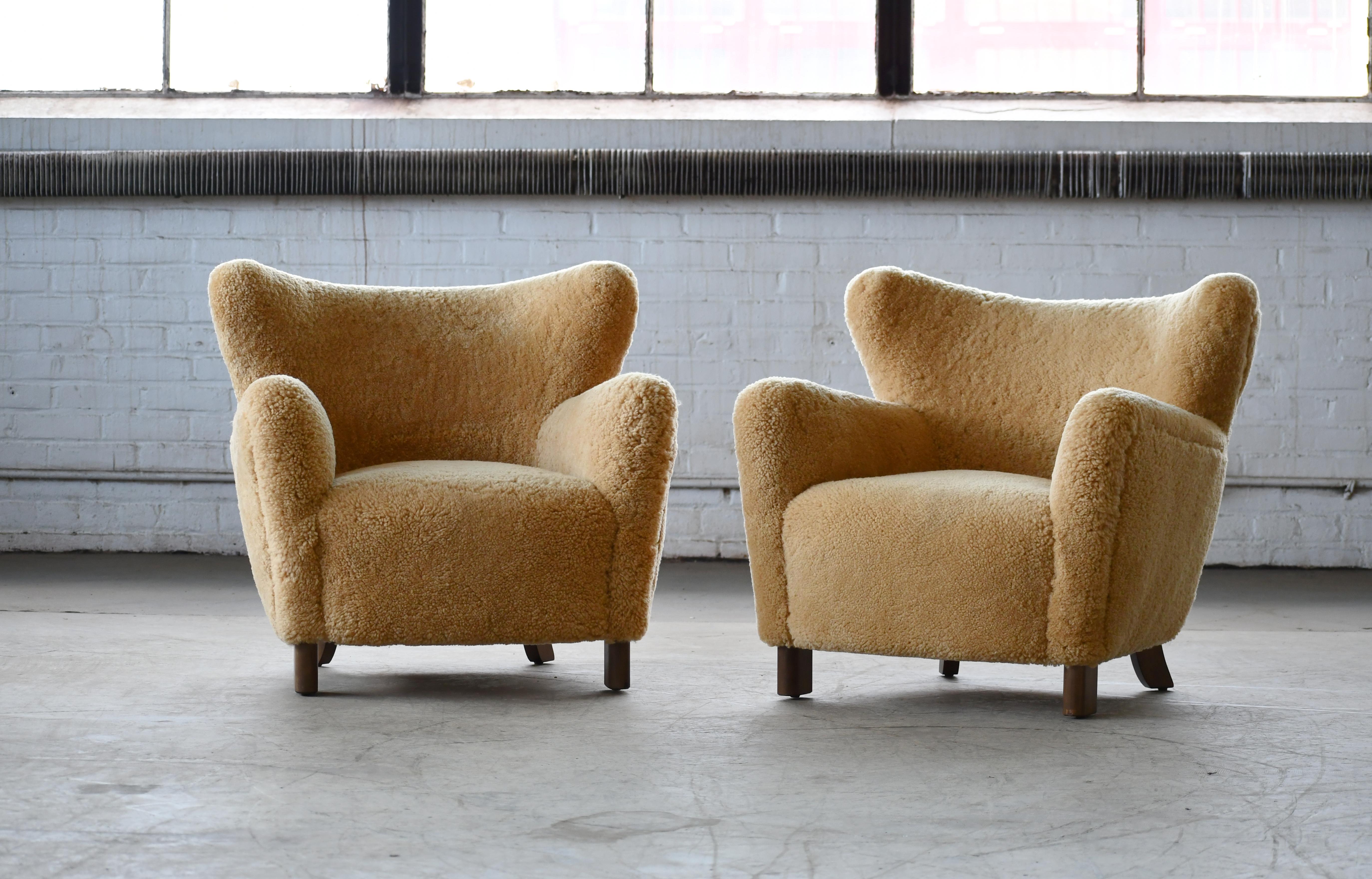 Beautiful exuberant pair of new Danish modern lounge chairs of our own design. The design is inspired by the classic designs from the 1940s but with our own design variations and up-dated dimensions. The chairs are based on a hand-built frame built