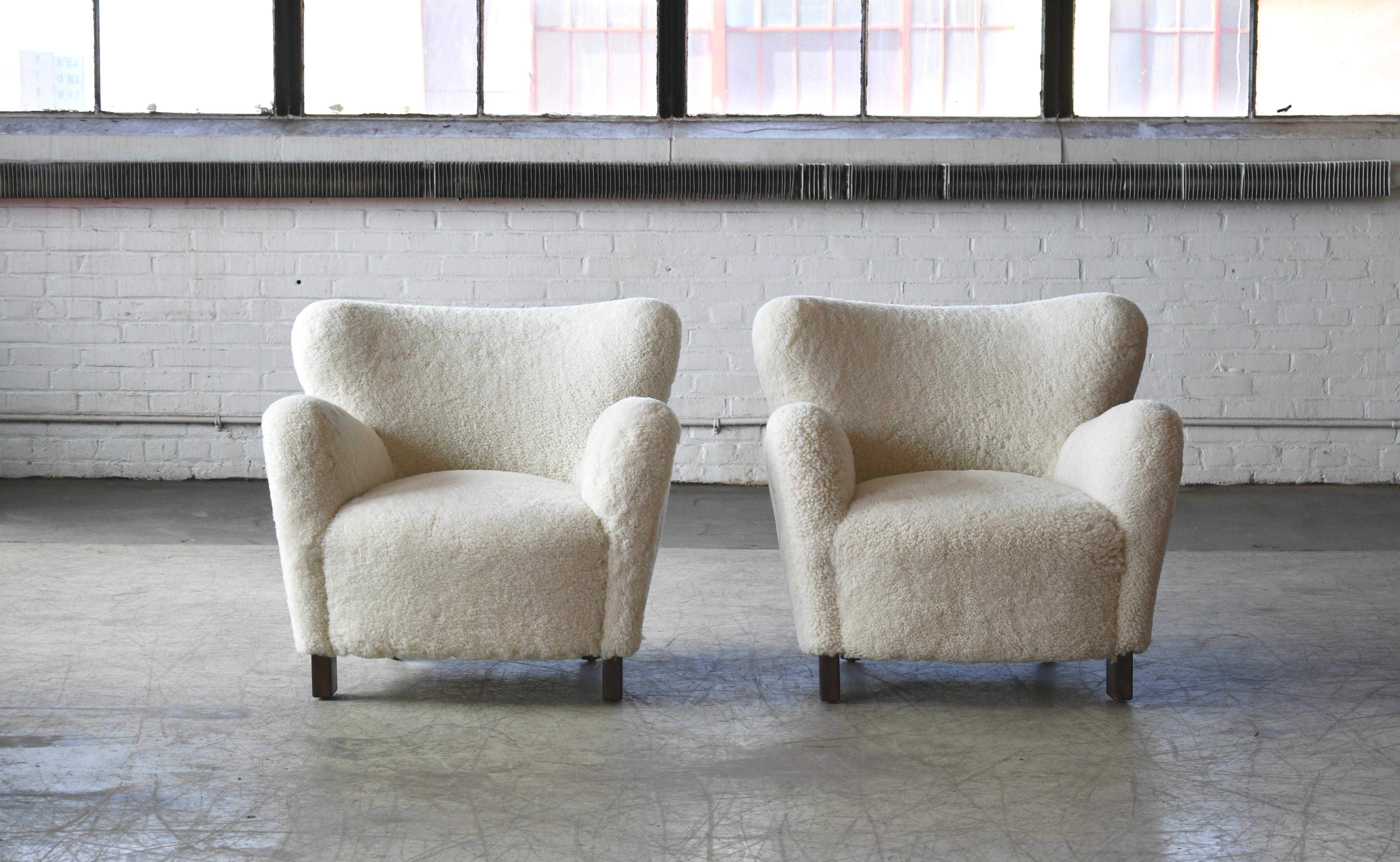 Beautiful exuberant pair of new Danish modern lounge chairs of our own design. The design is inspired by the Classic designs from the 1940s but with our own design variations and up-dated dimensions. The chairs are based on a hand-built frame built