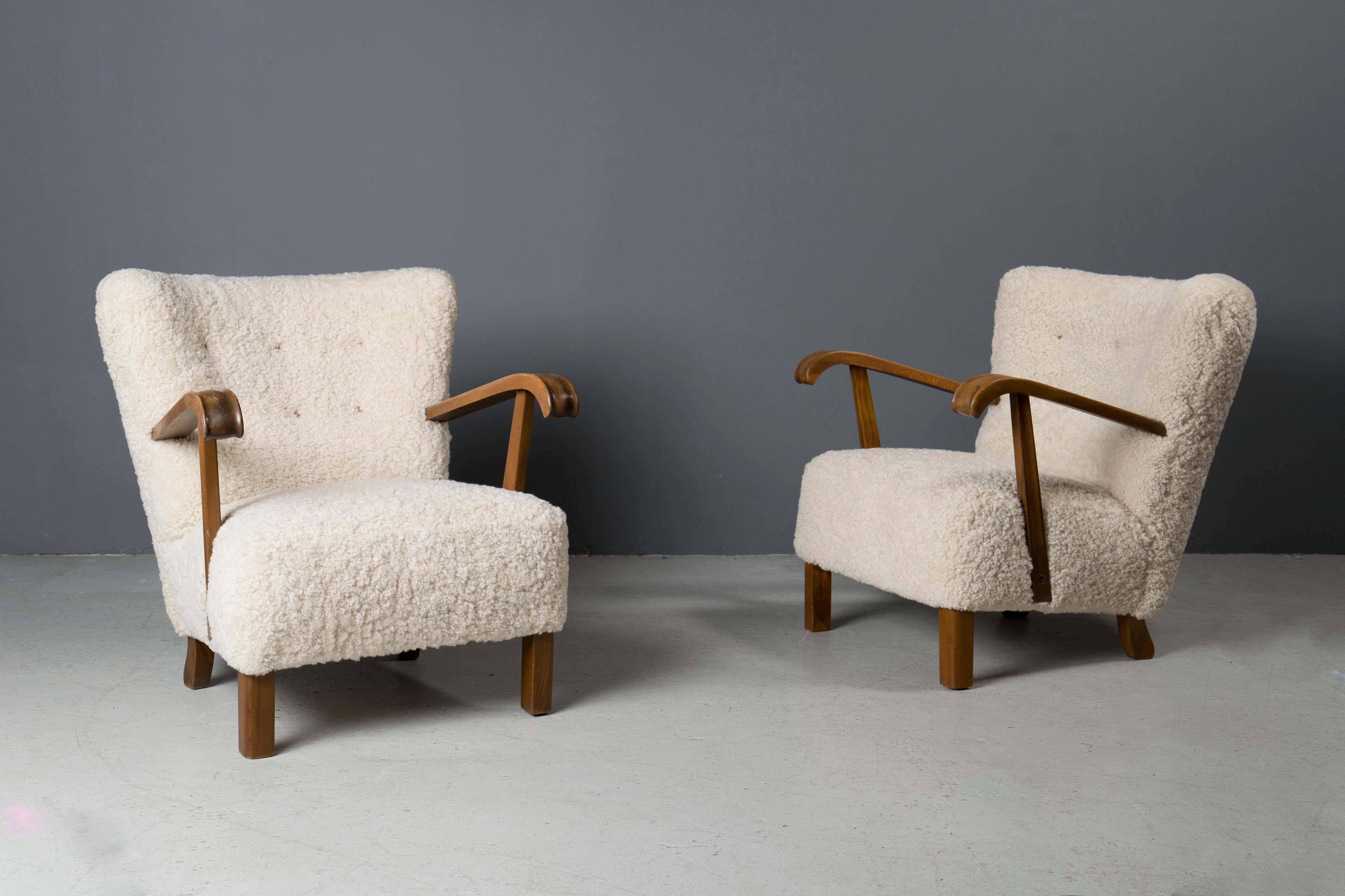 Pair of newly upholstered Fritz Hansen style Swedish chairs in shearling.