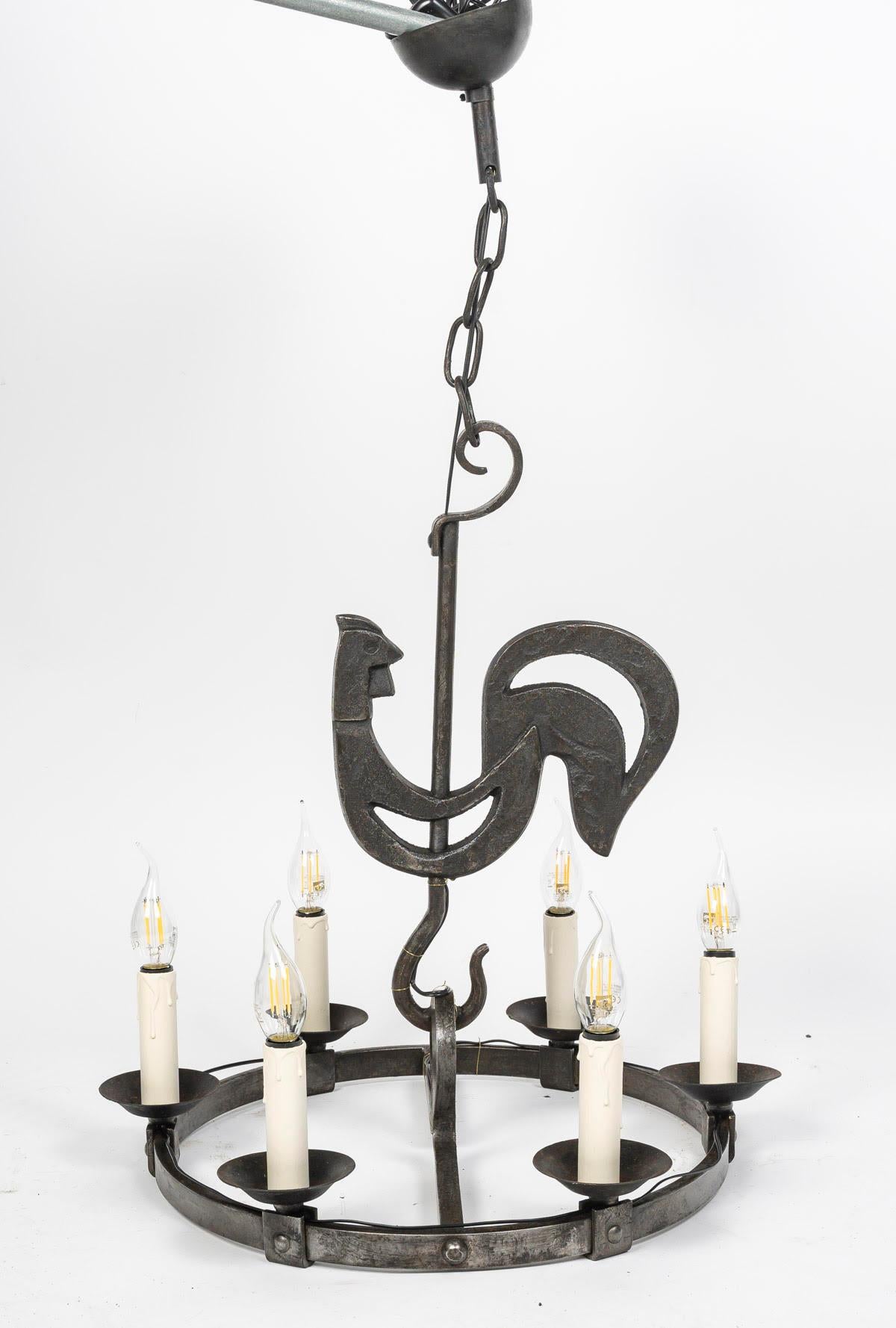 Pair of 1950s-1960s wrought iron chandeliers by Jean Touret, Marolles workshop.

Pair of wrought iron chandeliers by Jean Touret, Marolles workshop, 6 lights each, circa 1950-1960.
h: 83cm, d: 50cm
