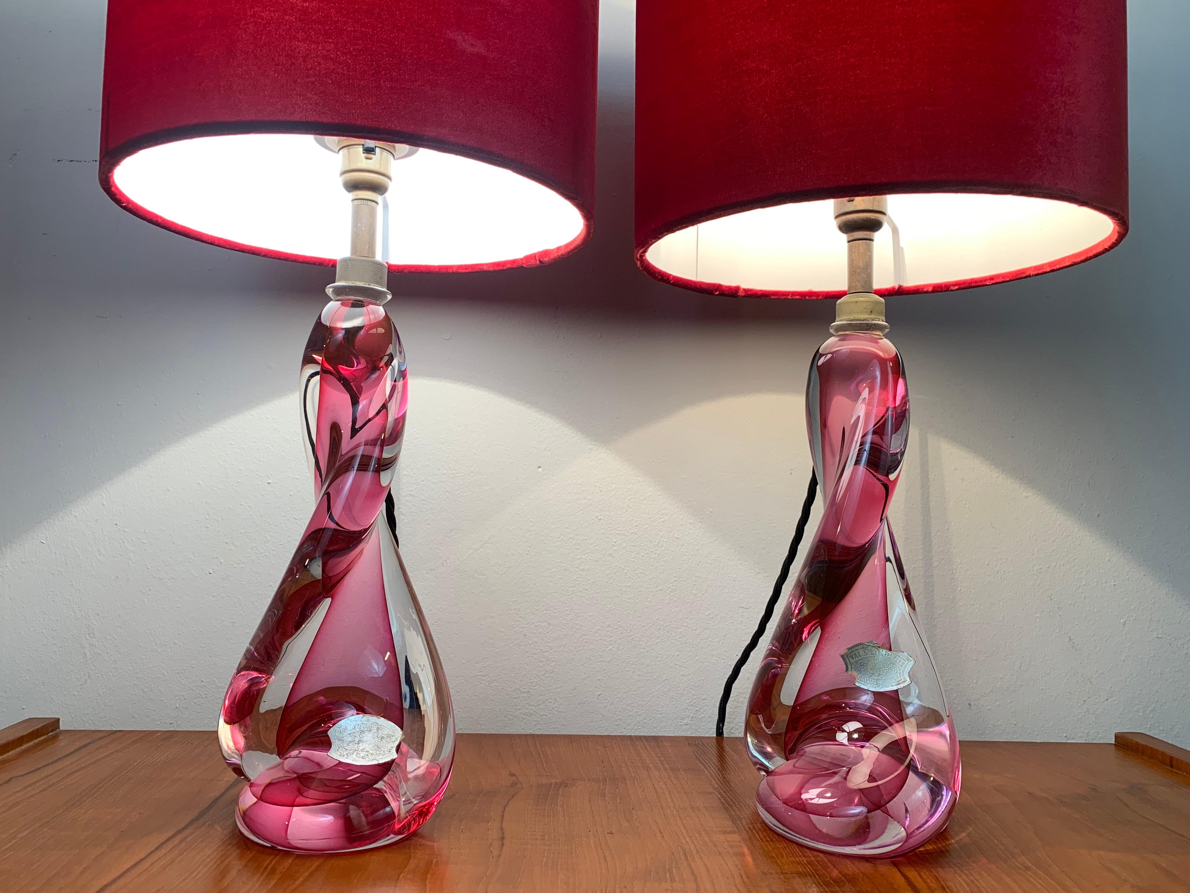 Pair of 1950s, Val St Lambert, pink and clear glass, twisted crystal lamp bases with brass mounted light fittings. Handmade in heavy lead crystal glass in Belgium. The brand new deep pink velvet shades are included. Both lamps have their original