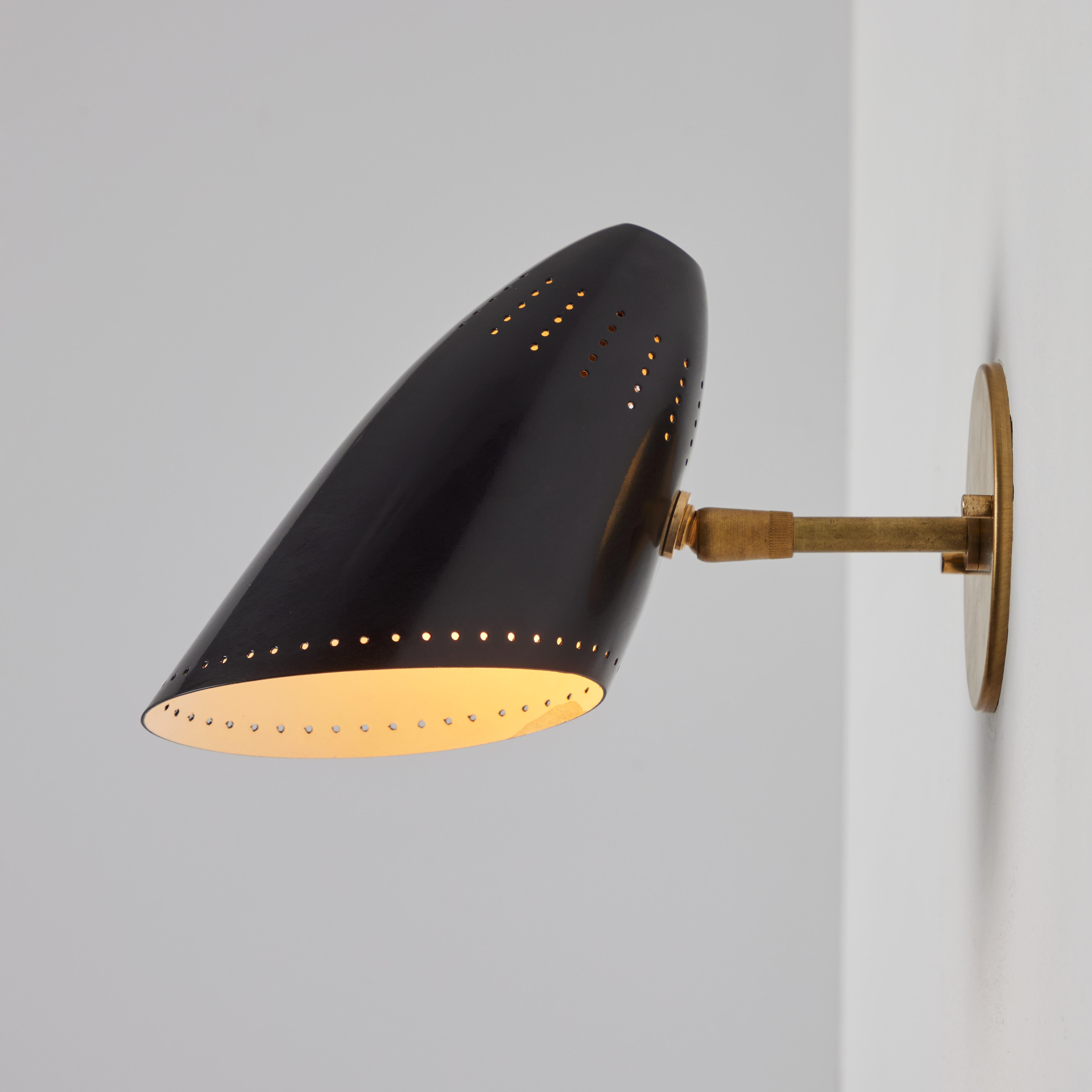 Pair of 1950s Black Perforated Sconces Attributed to Jacques Biny. 

An exceptionally clean and simple design executed in perforated black metal shade with custom period-style brass backplate added for mounting over standard US j-box. The shade