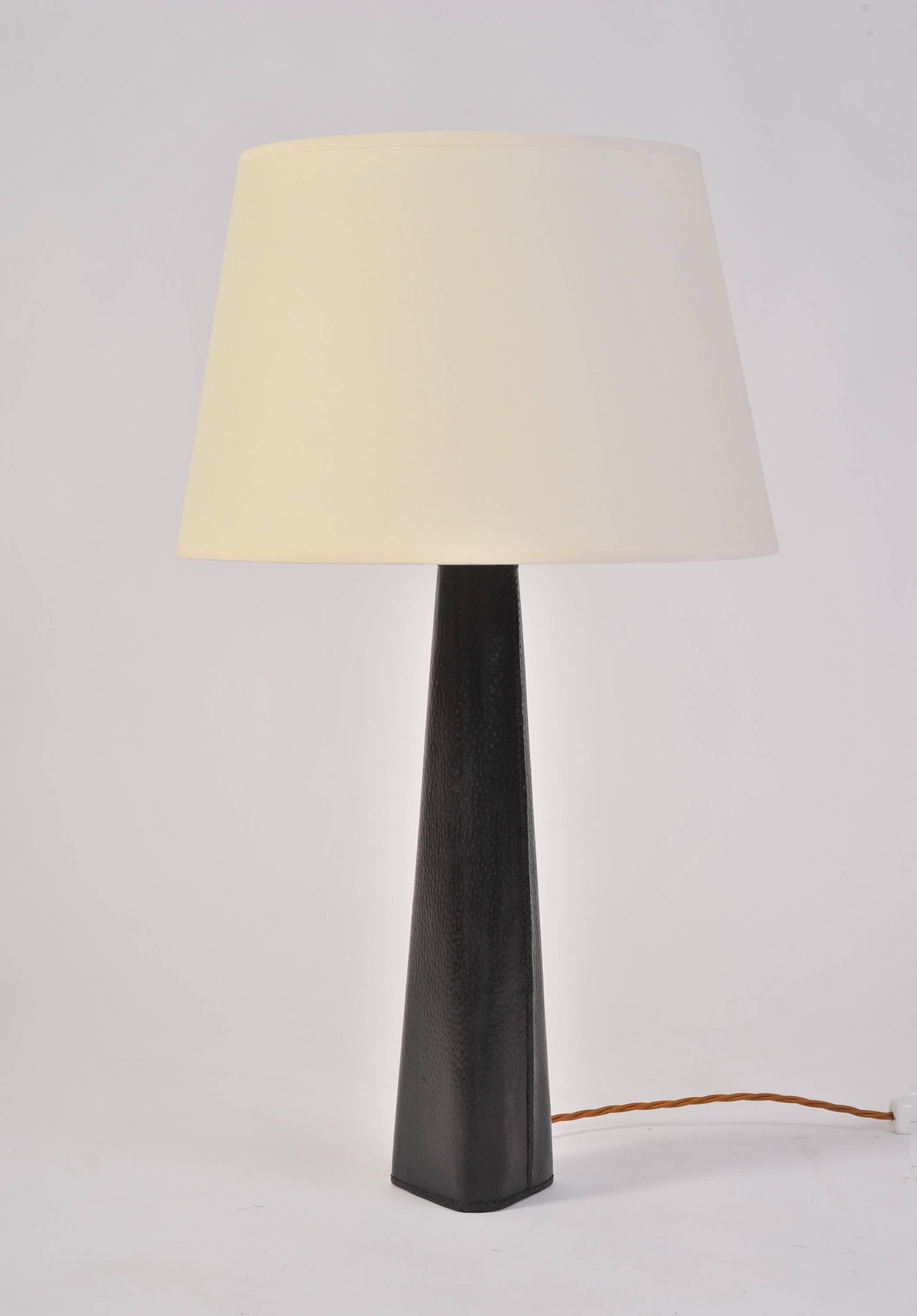 A pair of black stitched leather table lamps,
France, circa 1950.
