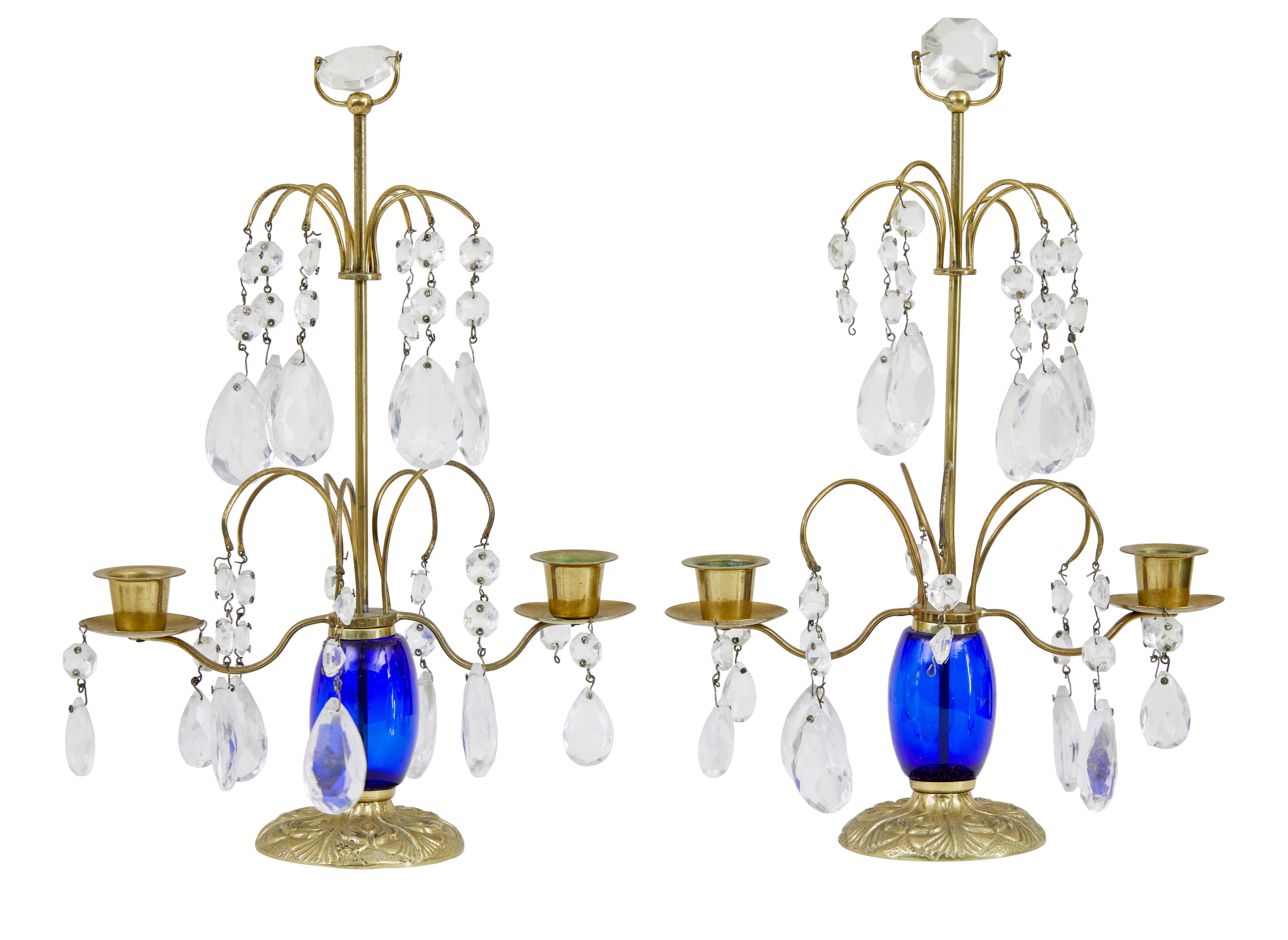 Pair of 1950’s brass and cut glass decorative candlesticks.

Brass stem and arms, adorned with cut glass. Bristol blue stem. 3 droplets missing, but should be easy for buyer to source.

Stunning piece for the dining table.