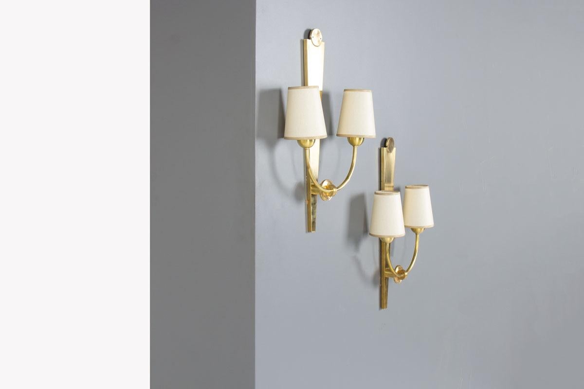 Bring a touch of timeless mid-century elegance to your interior with this exquisite pair of 1950s brass wall lights.
Each sconce features two light points adorned with handcrafted paper lampshades, designed to cast a warm and gentle