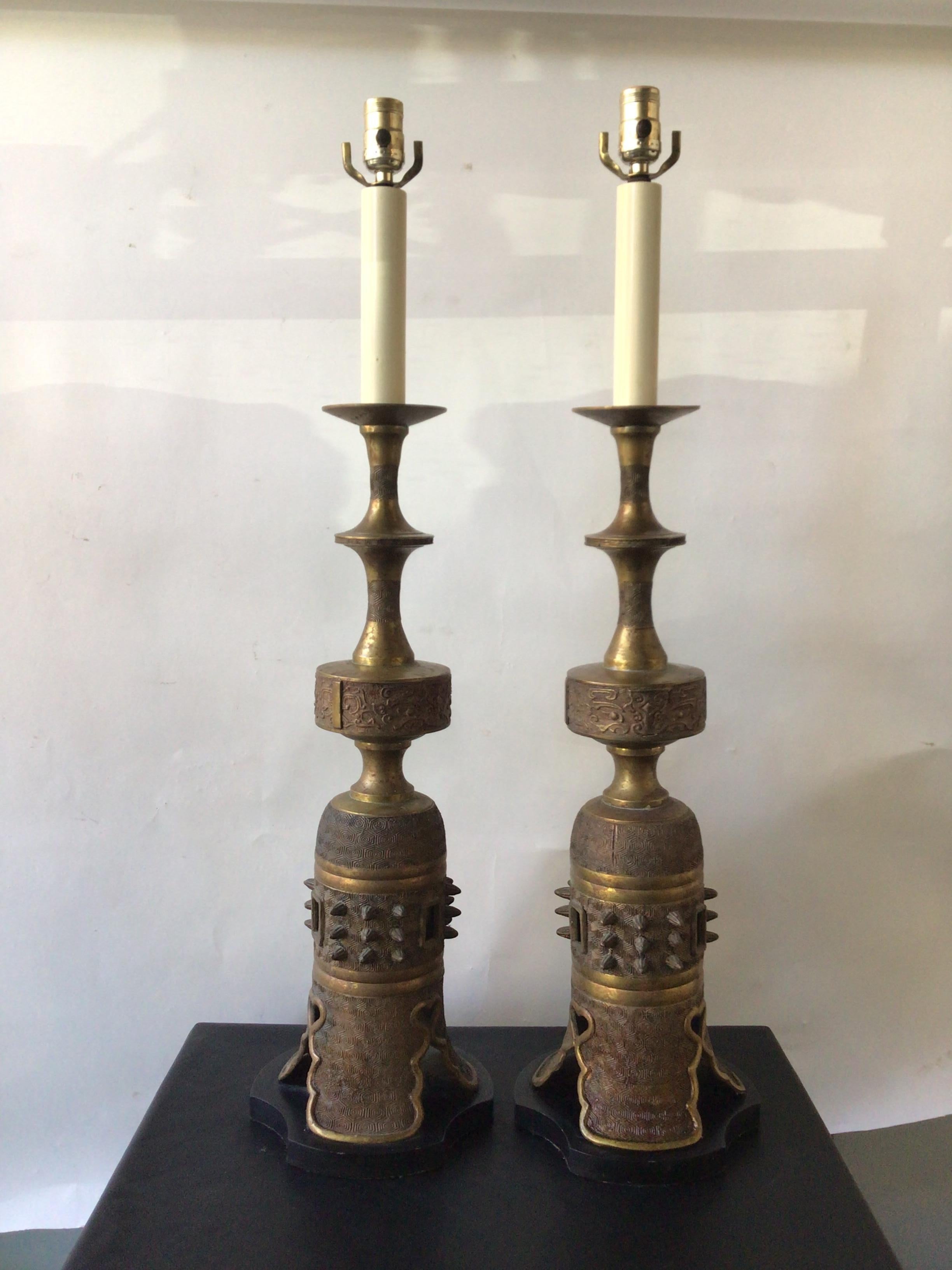 Pair of 1950s James Mount style bronze Asian lamps on metal bases.