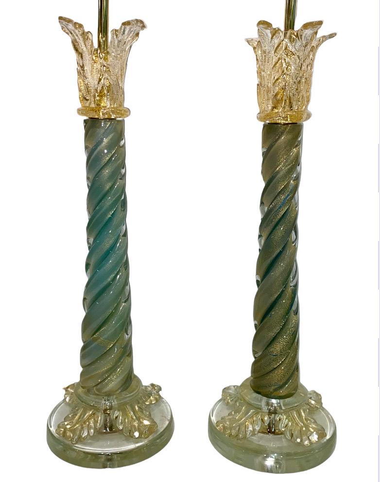 A beautiful pair of 1950s classical style column Venetian glass table lamps from Murano, Italy. Each lamp is hand blown and formed in what is called aventurine glass. That is glass with actual gold flecks within it. The lamps have a central twisted