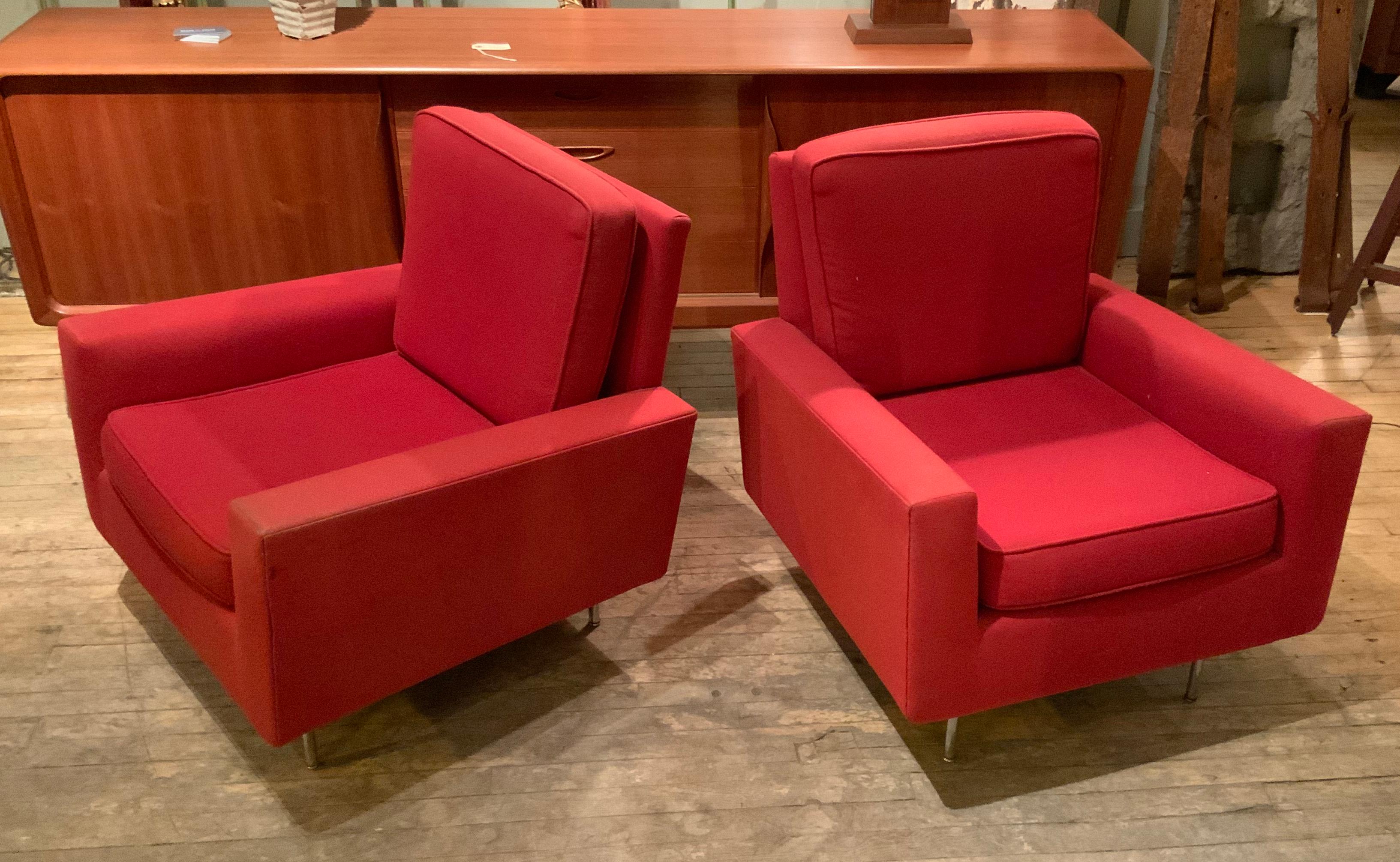 A beautiful and rare pair of modern 1950s club chairs designed by Florence Knoll for Knoll International. Classic design with angled back and loose seat and back cushions, raised on chromed steel legs. In their original red upholstery, which shows