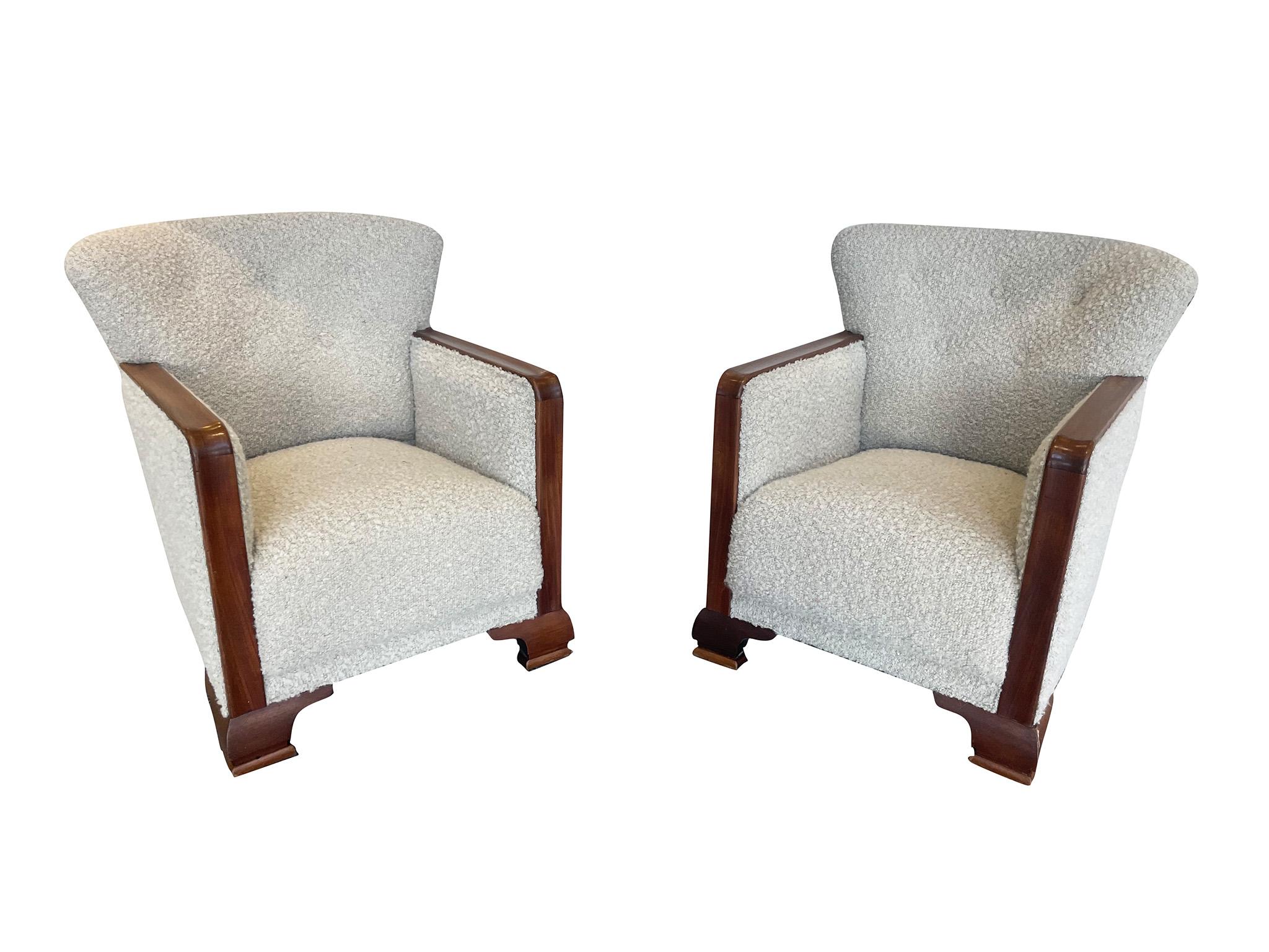 Wonderful pair of 1950s Danish Club Chairs in the style of Fritz Hansen’s Model 1669 chair. Melding Scandinavian Modern and Art Deco design elements, the chairs are characterized by their right-angle wood armrests, deep seat cushion, slight