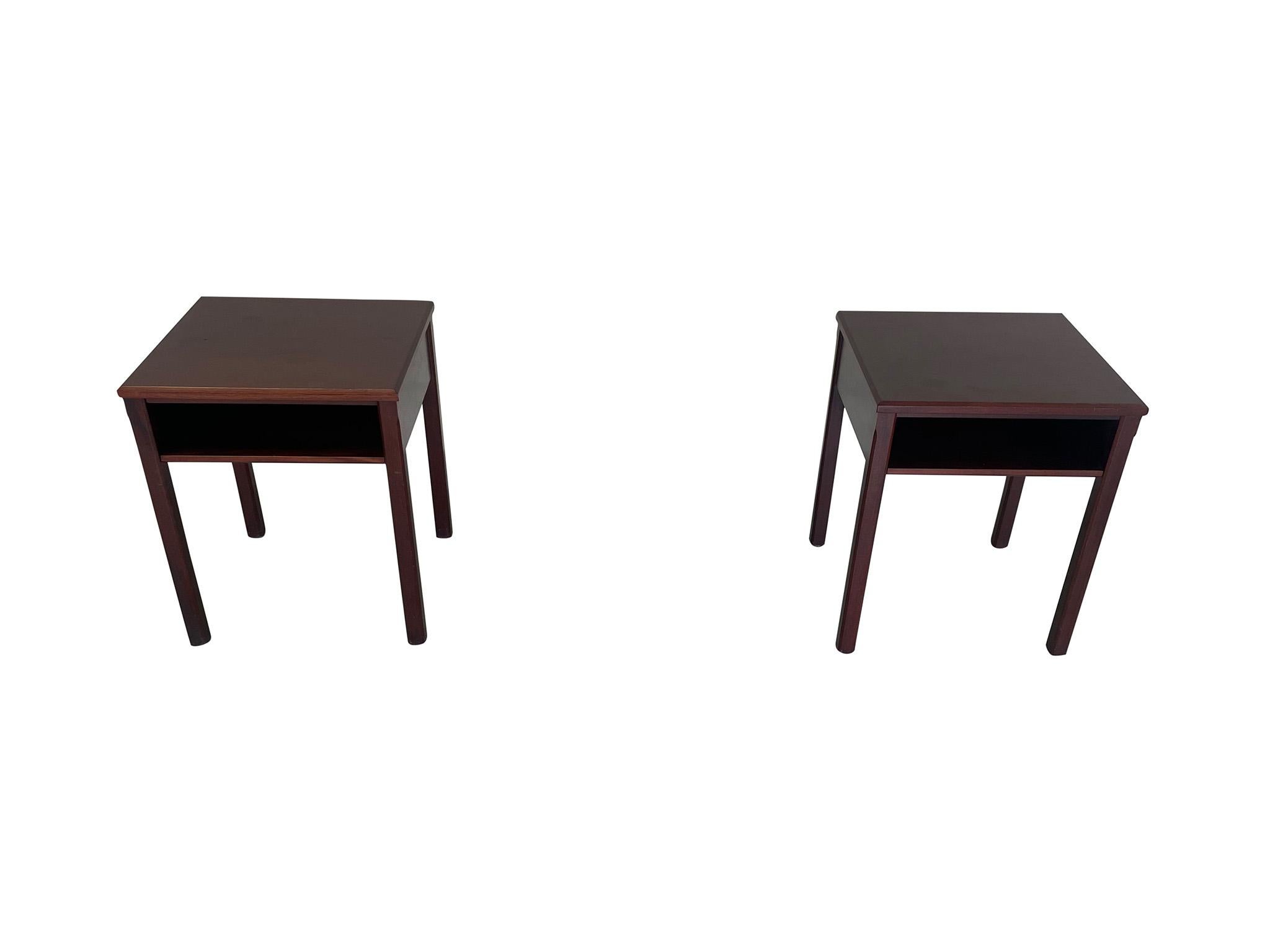 Lovely pair of 1950s Danish Modern nightstands, with makers mark of Lysberg, Hansen, and Therp on underside. Crafted in a high quality mahogany, the tables are designed with Classic clean lines, single open shelves, and simple fluted edge legs. A
