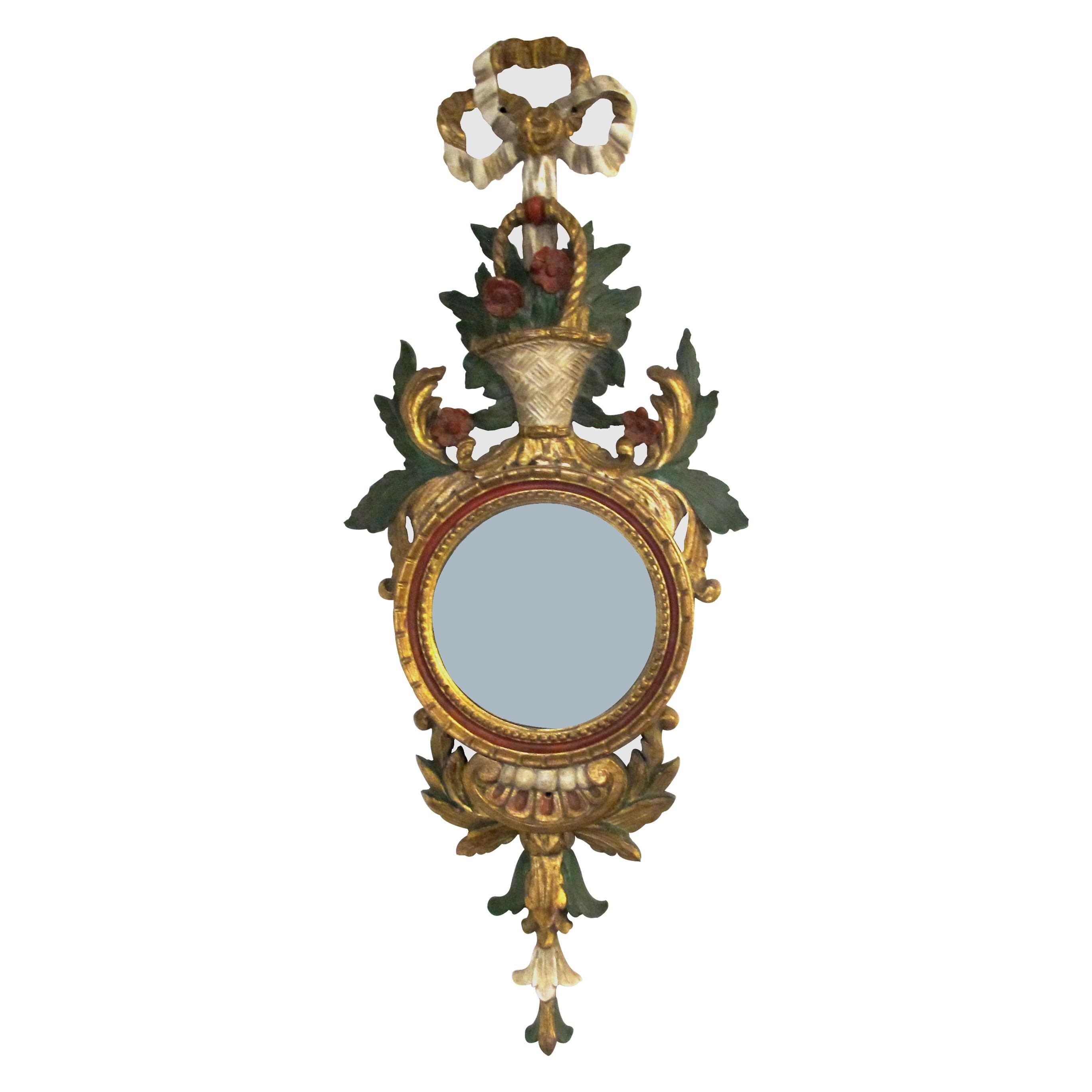A beautiful pair of highly decorative, mid-century, mirrored wall sconces with giltwood and convex mirrors. The carving features flower baskets with ornate coloured and gilt leaves and flowers. The sconces were made in Firenze, Italy in the